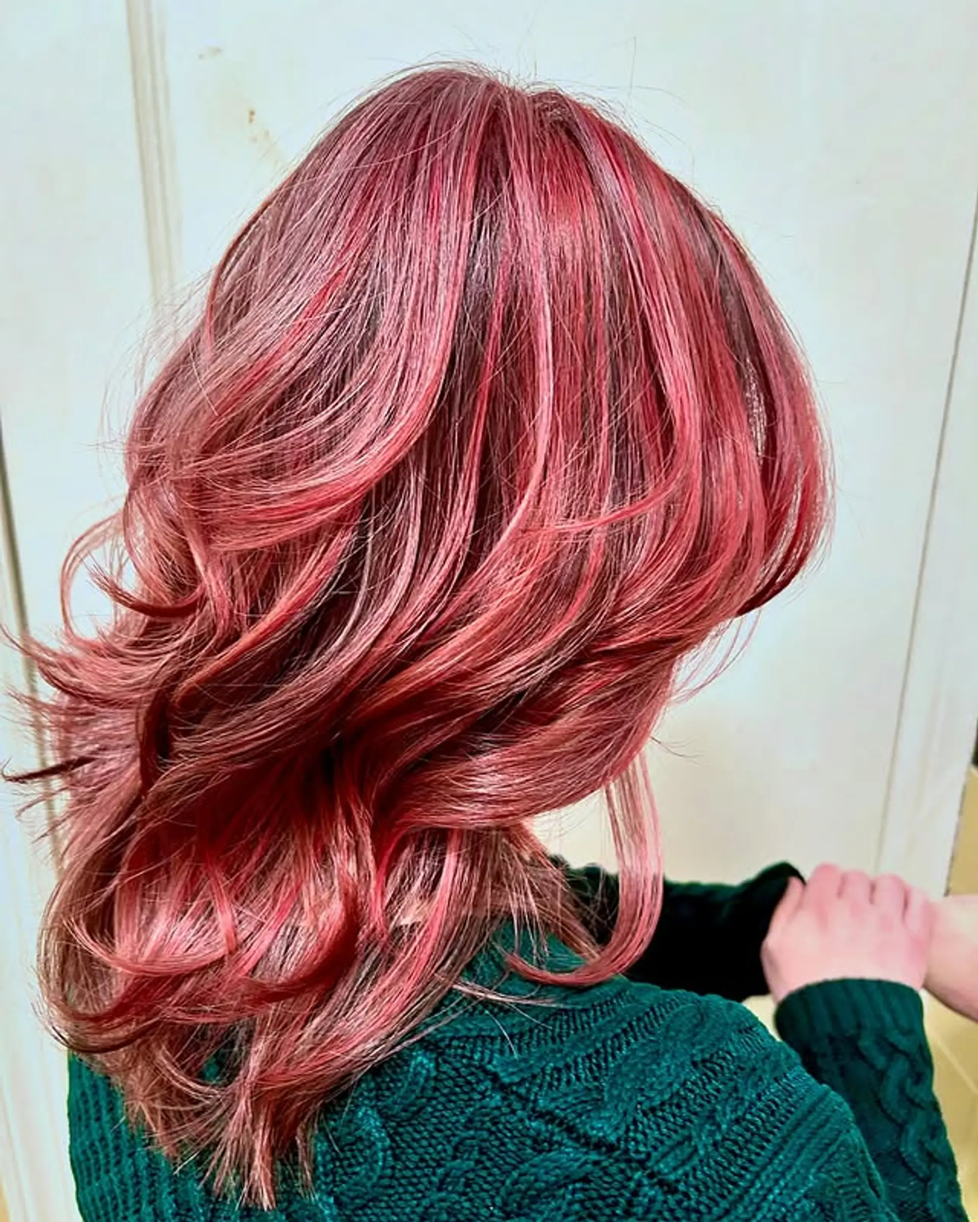 A medium-length layered shag with choppy, face-framing layers and curtain bangs. 1