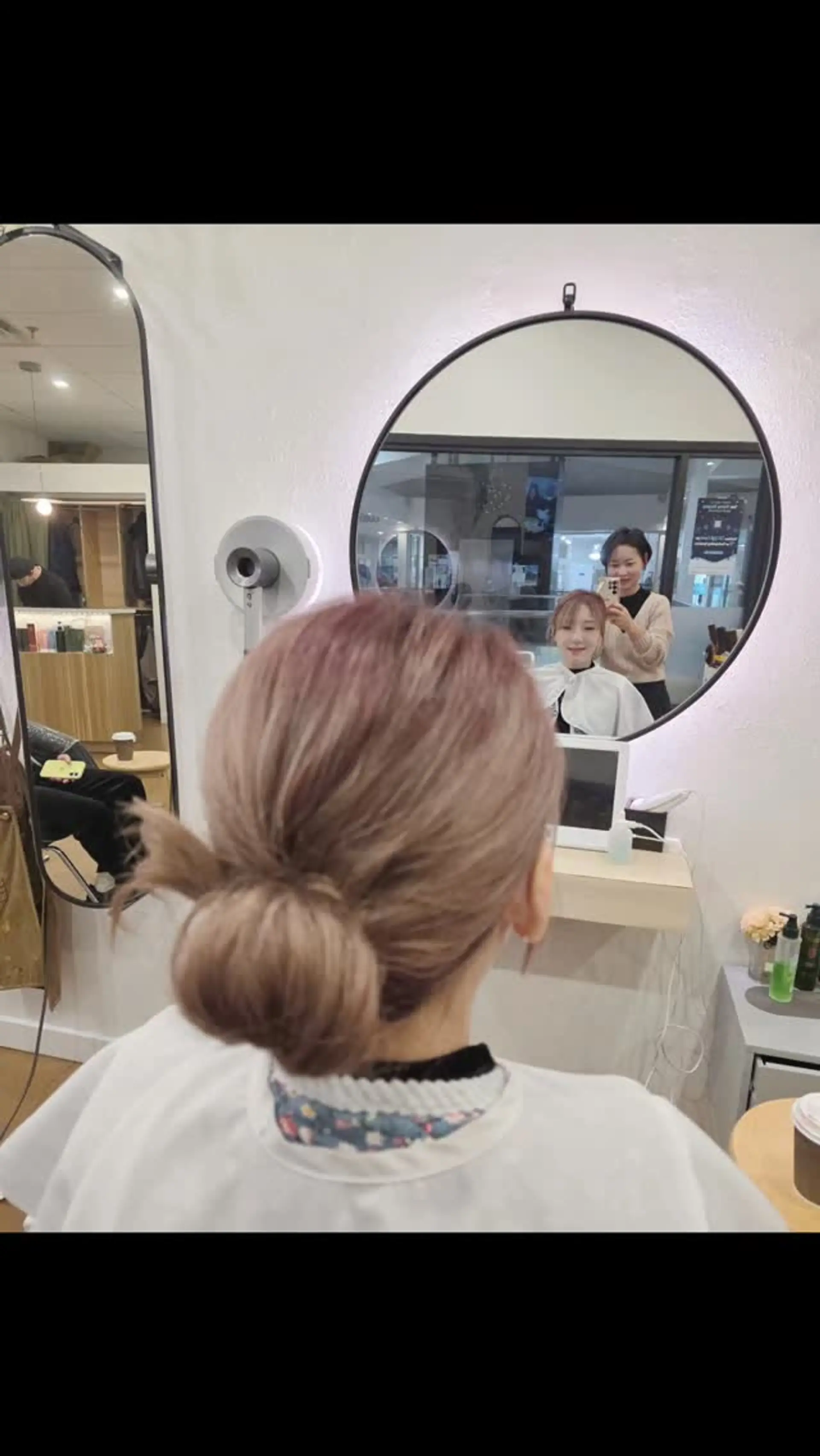 A sleek and soft low bun updo gathered gracefully at the nape of the neck. 1