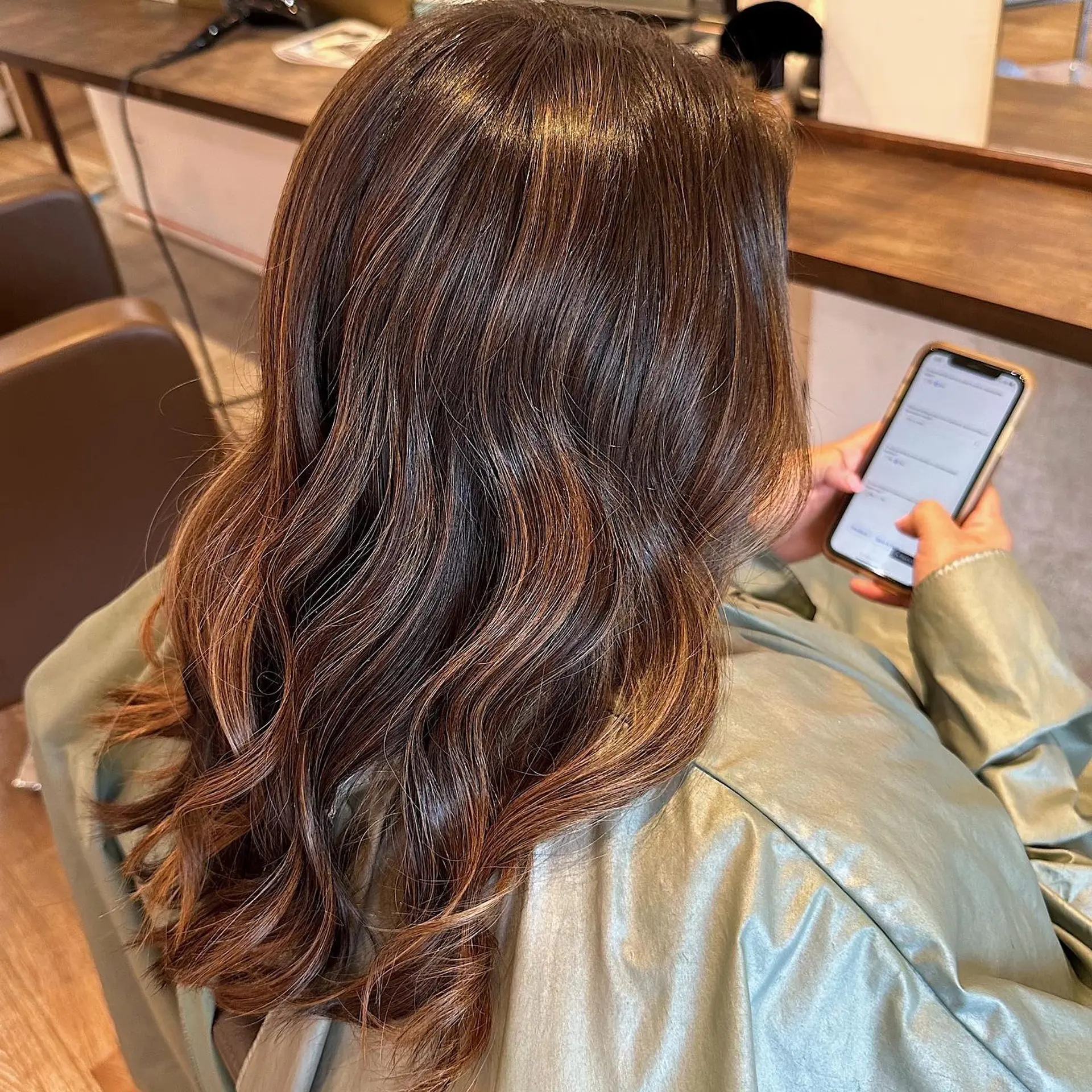 A long, wavy hairstyle featuring a caramel swirl balayage. 1