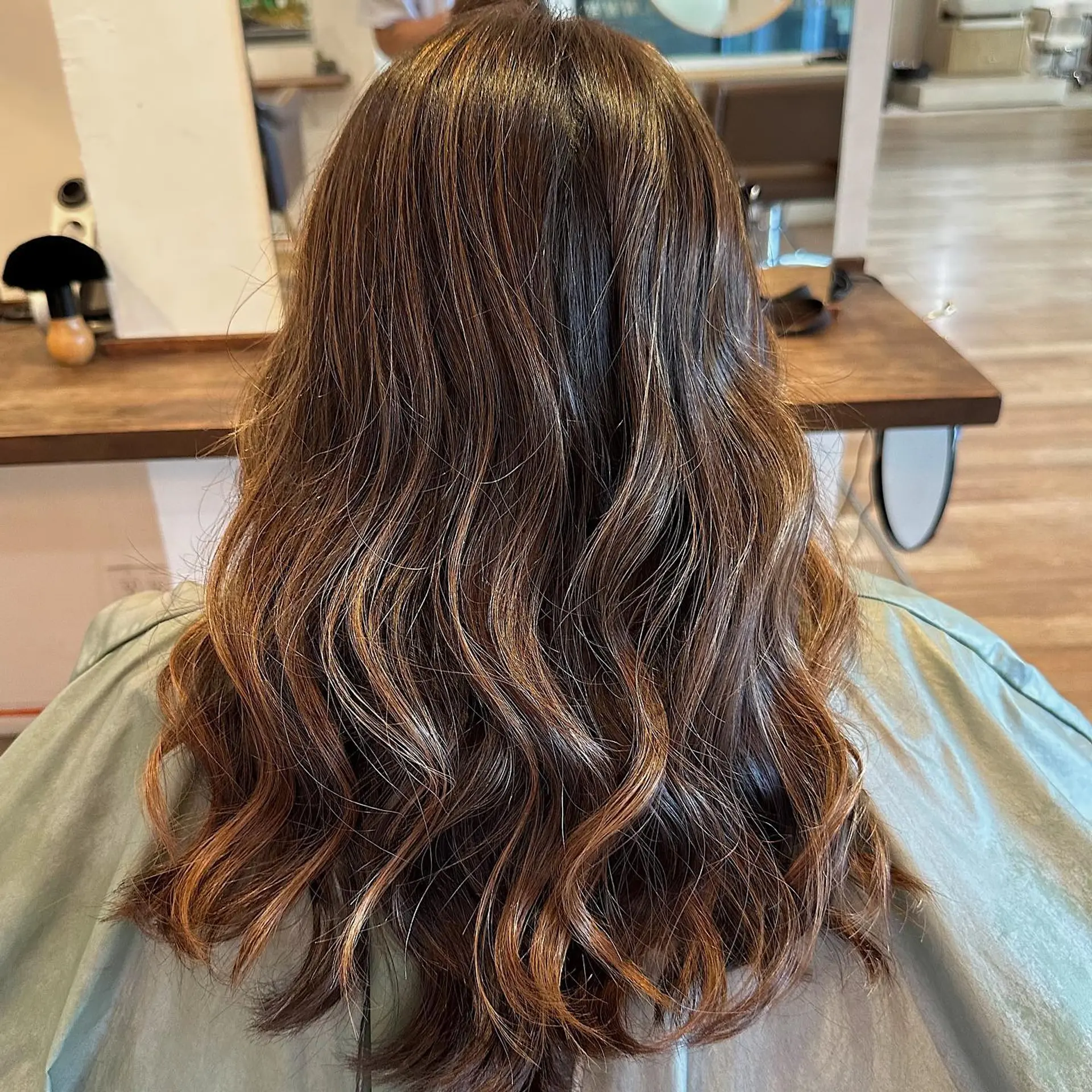 A long, wavy hairstyle featuring a caramel swirl balayage. 2