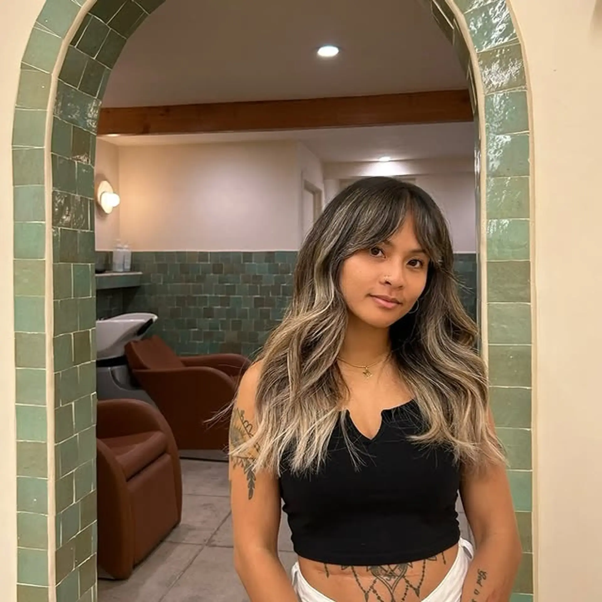 Long layered hair with curtain bangs and subtle ombre highlights. 1