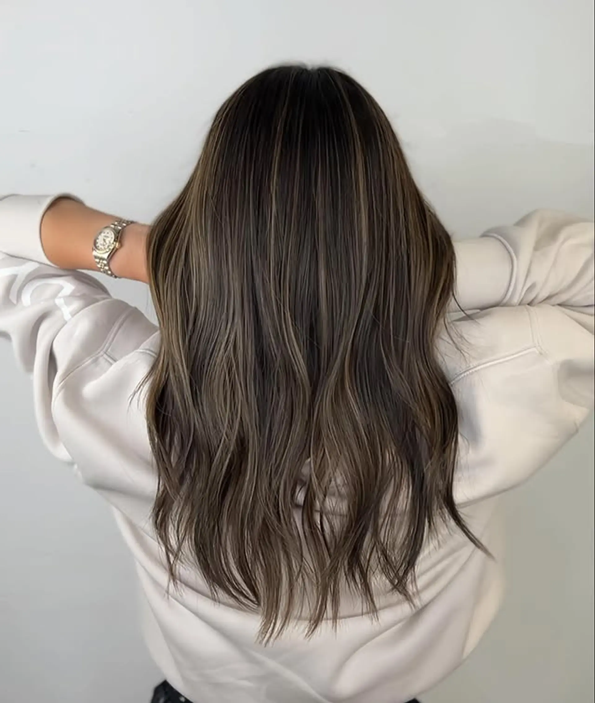 A long, wavy bronde balayage with soft, subtle highlights. 1