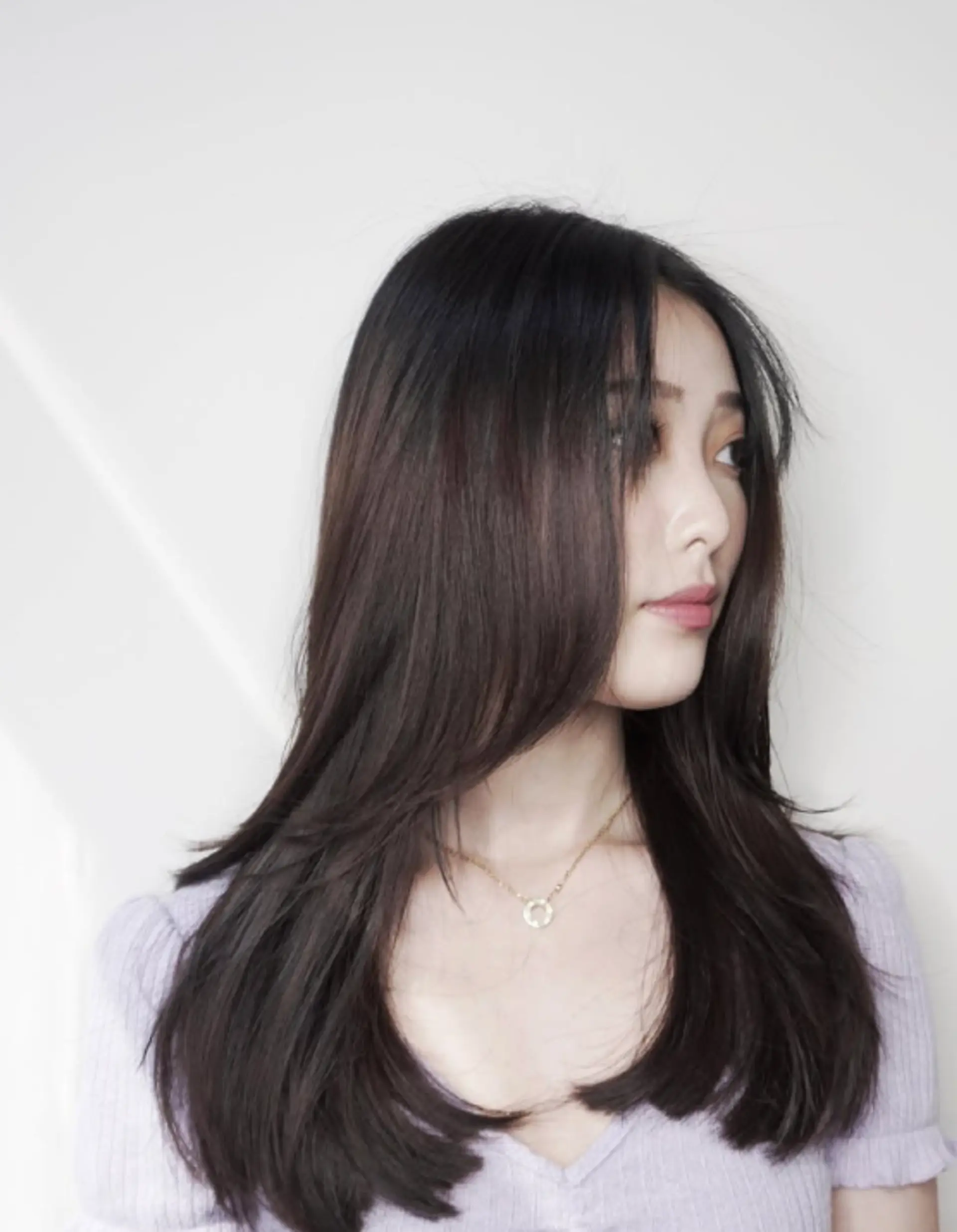 Long layered haircut with soft, face-framing layers. 1