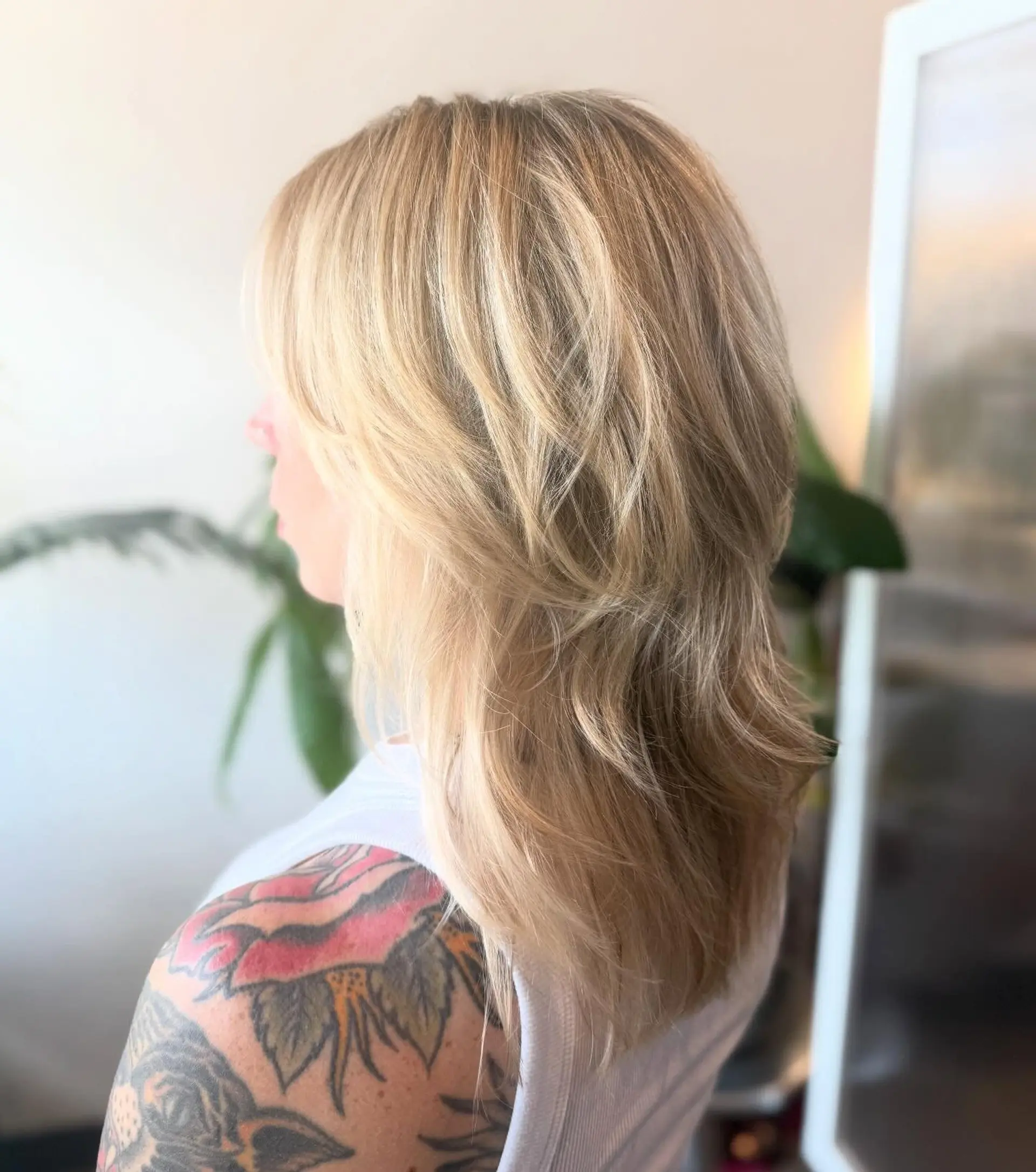 A textured blonde shag haircut featuring feathered face-framing layers and soft, dimensional body. 1