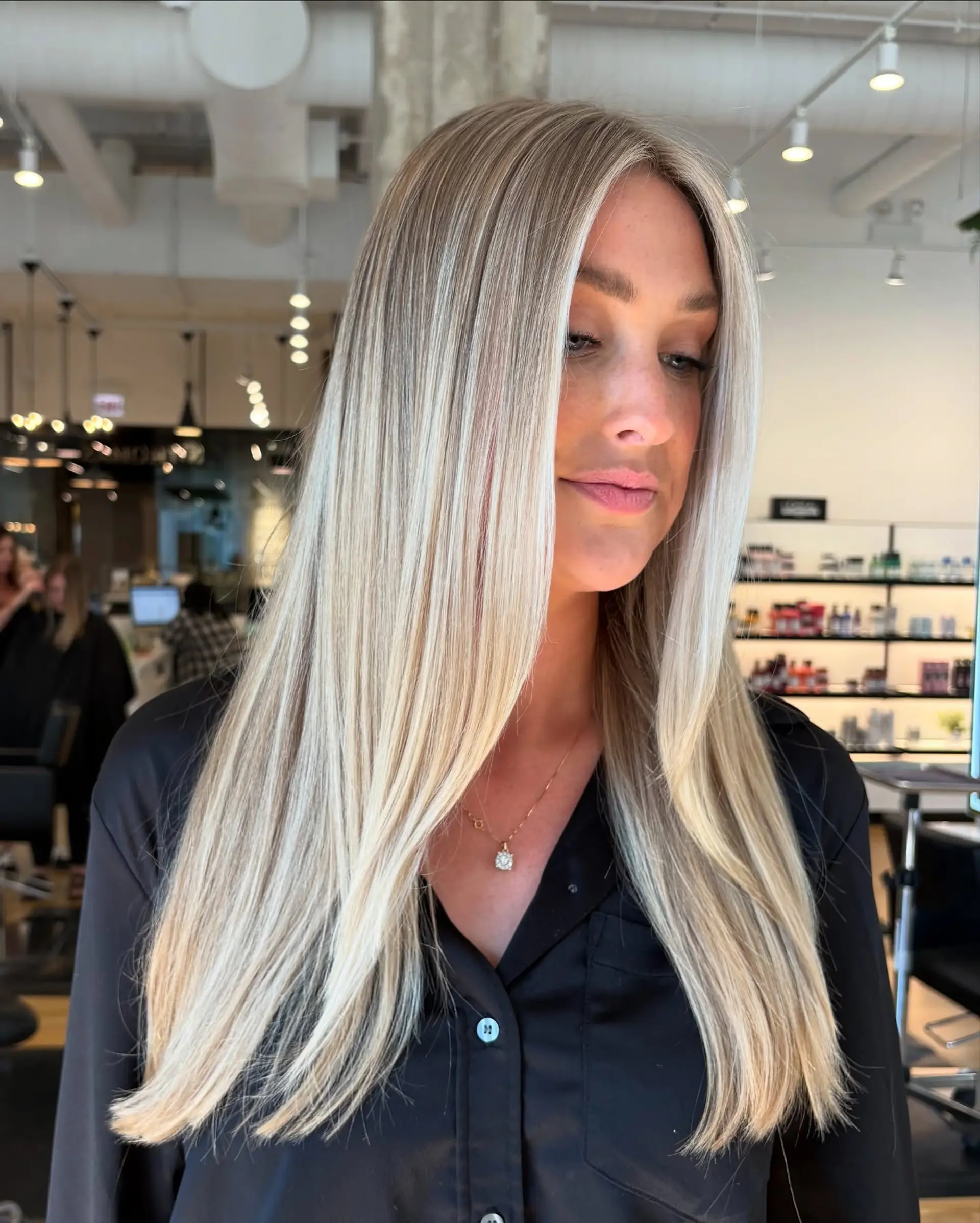 Long, straight bright blonde hair with seamless root blending and face-framing highlights. 1