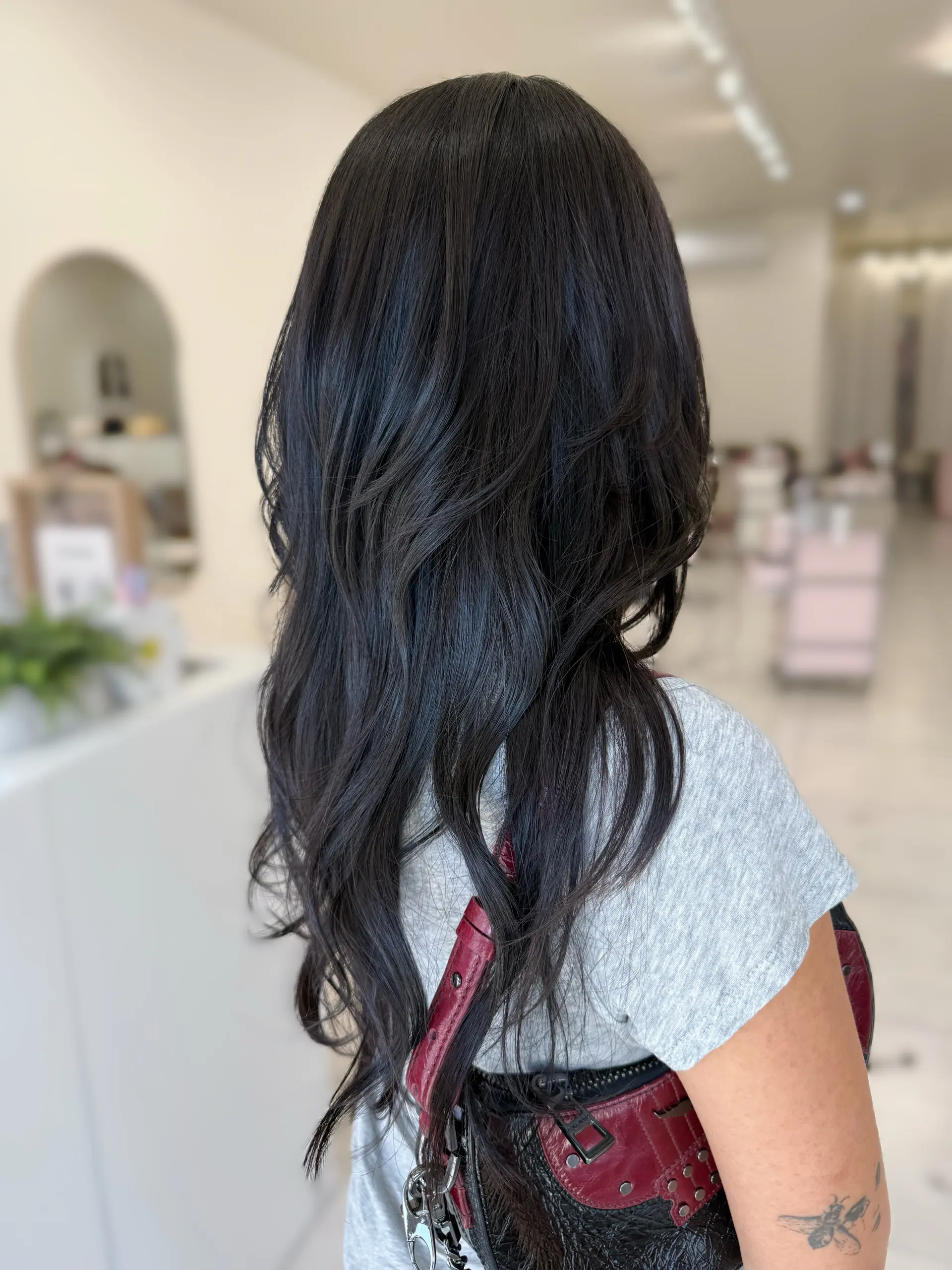 A soft, textured hush cut with cascading layers and subtle waves on long, natural black hair. 1