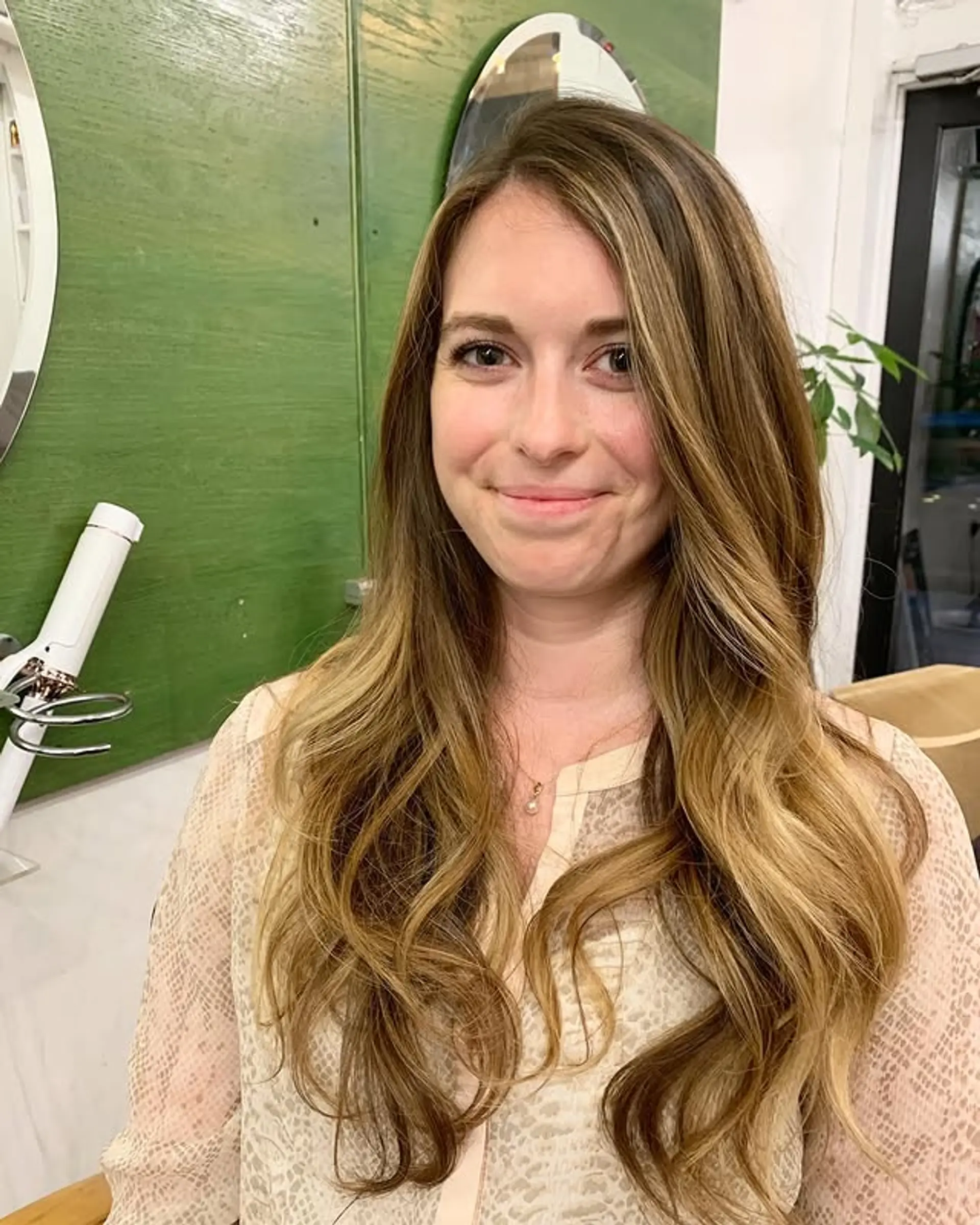 Long, wavy hair with a bronde balayage and soft, beachy waves. 1