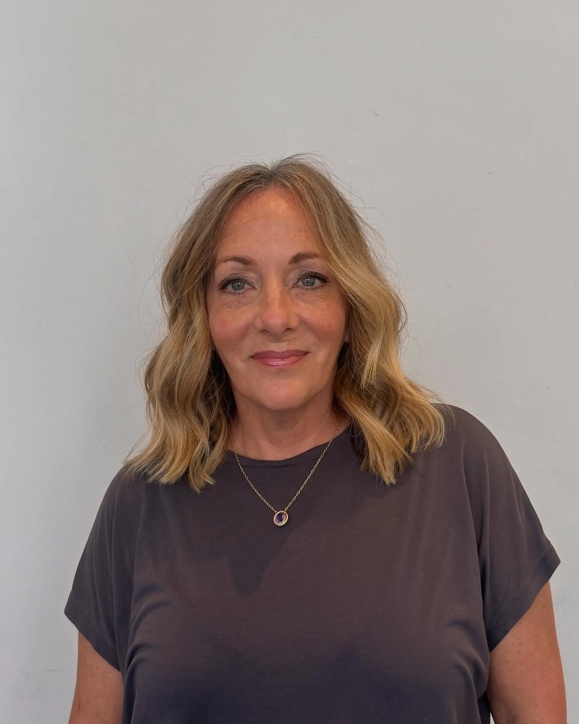 Collarbone-length one-length lob styled with loose, relaxed waves and a soft center part. 1