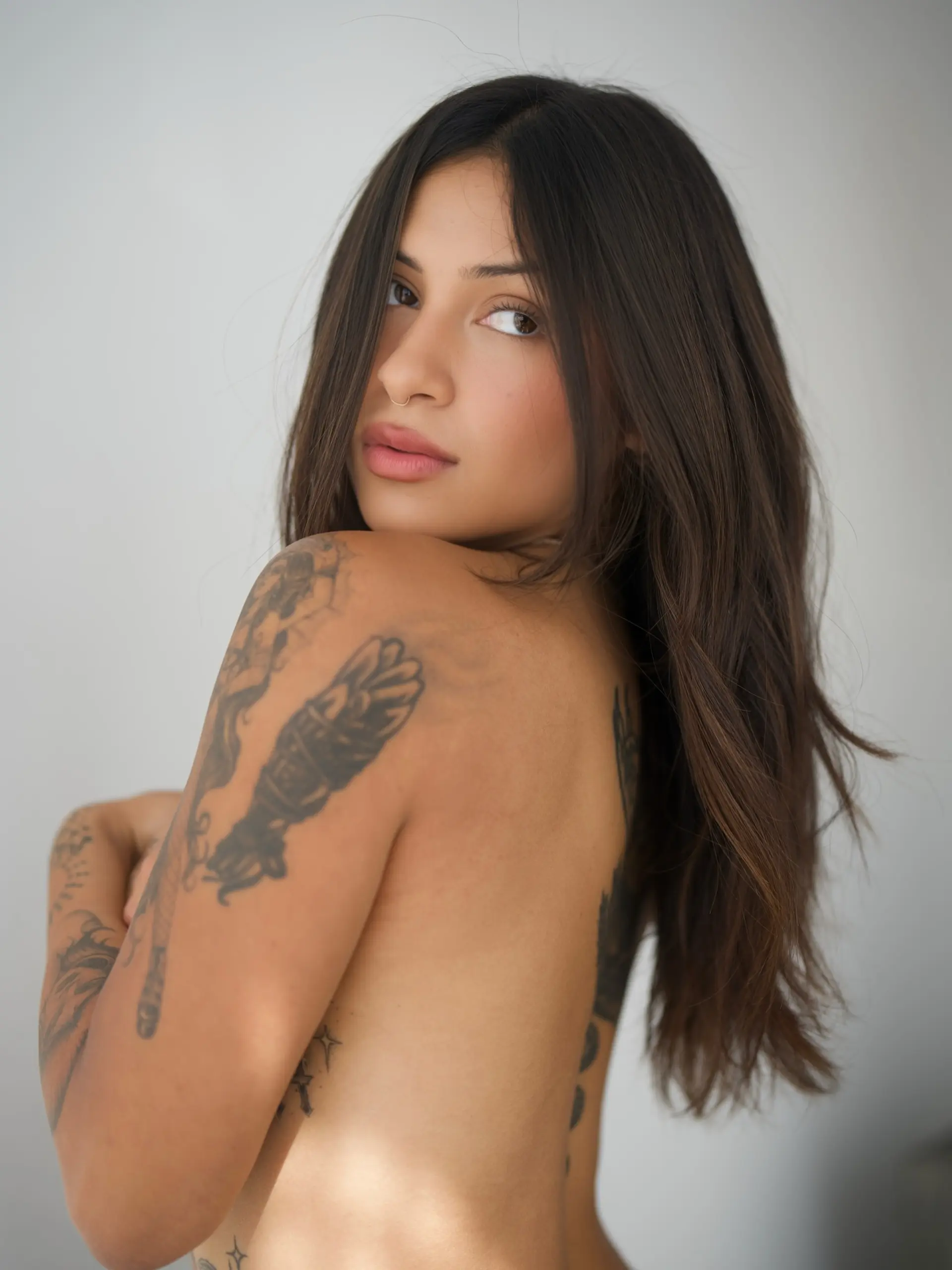 Long, flowing dark brunette hair featuring subtle, rich dimensional tones and soft natural movement. 1