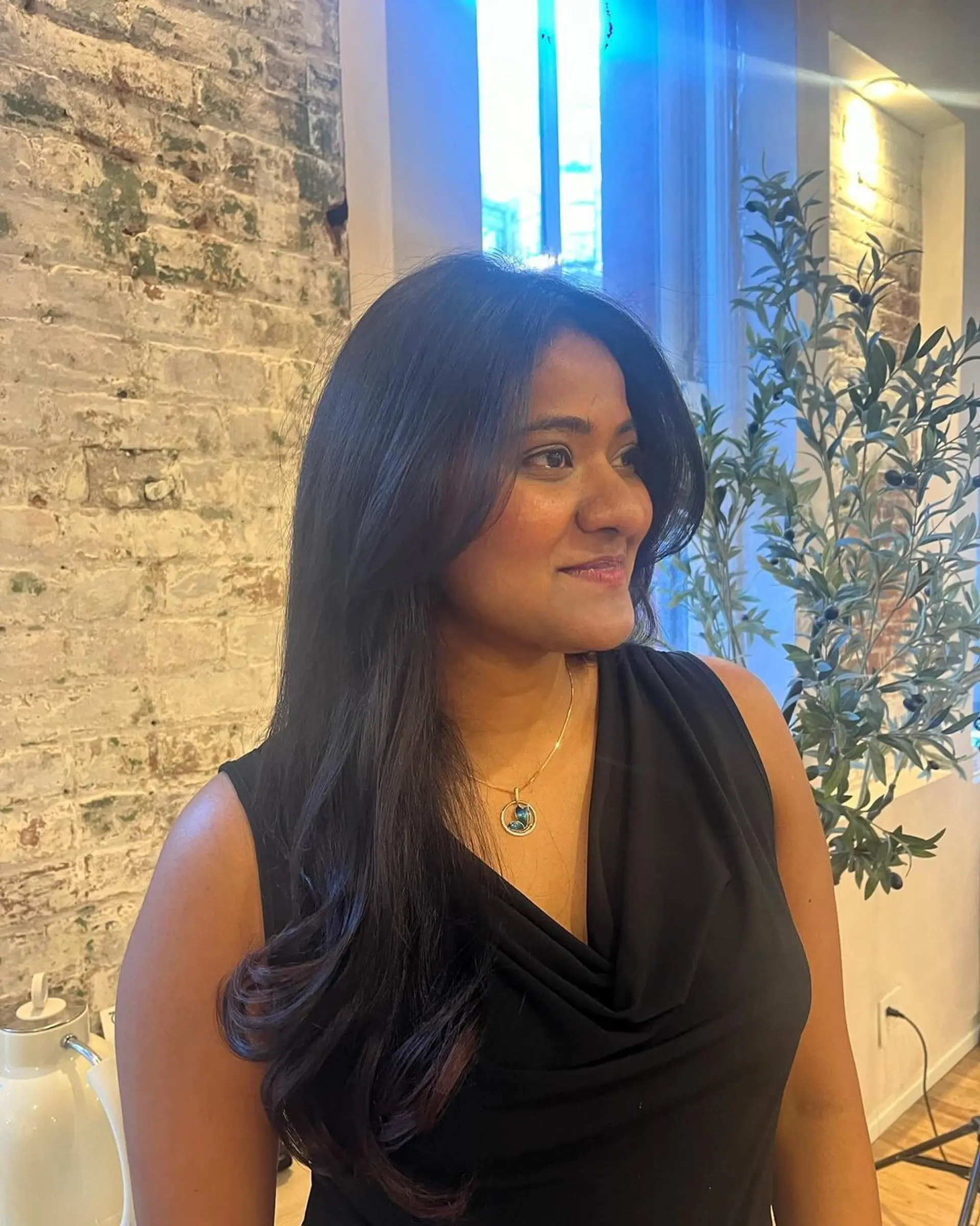 Long, sleek, straight black hair with a side parting and soft waves towards the ends, presenting a smooth and shiny finish. 1