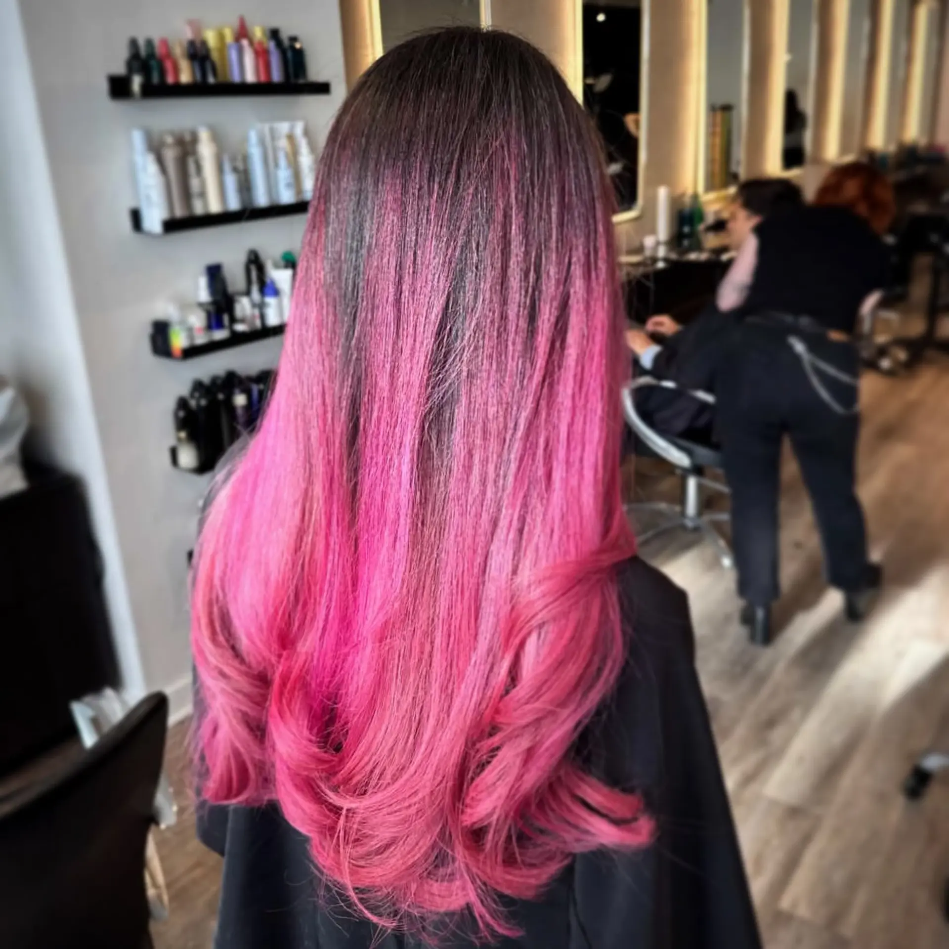 Long dark-rooted hair transitioning into vibrant hot pink with soft, voluminous curls at the ends. 1