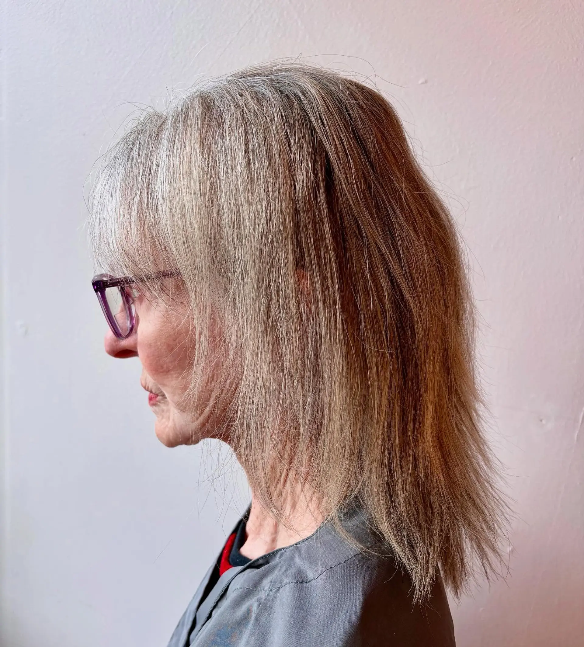 Medium-length straight ash silver hair styled with soft, wispy bangs and textured layers. 1