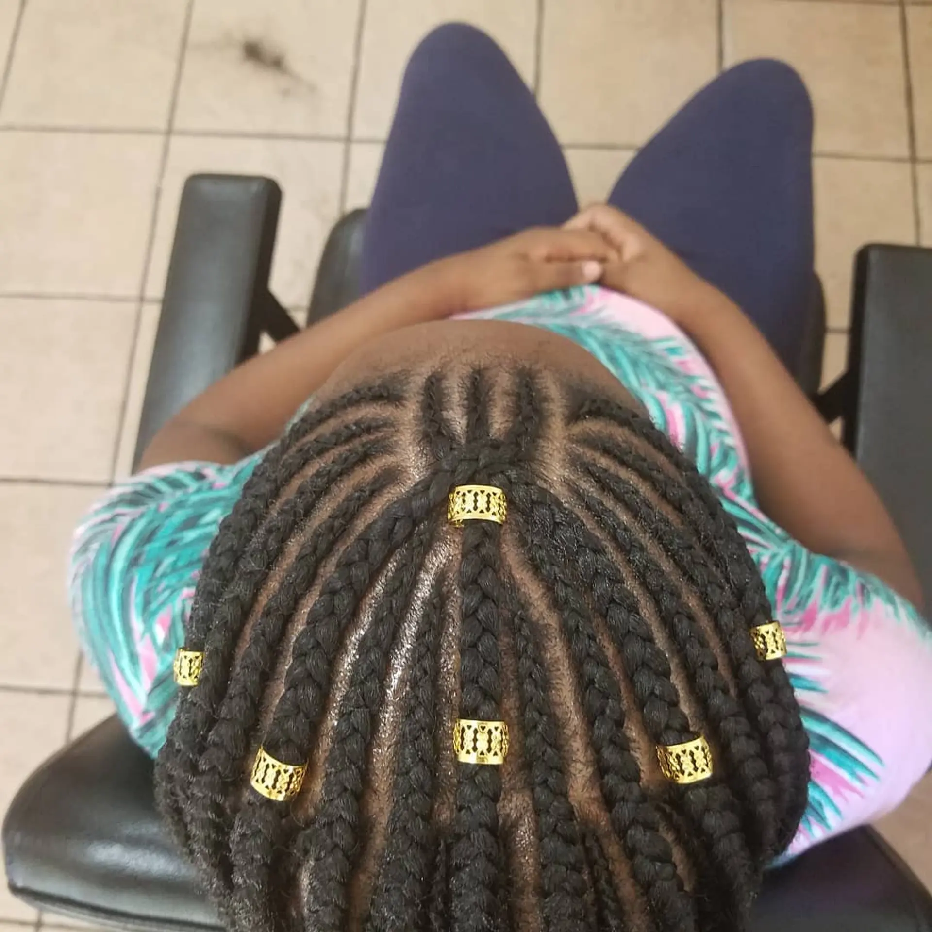 Neat cornrow braids with gold accessories. 1