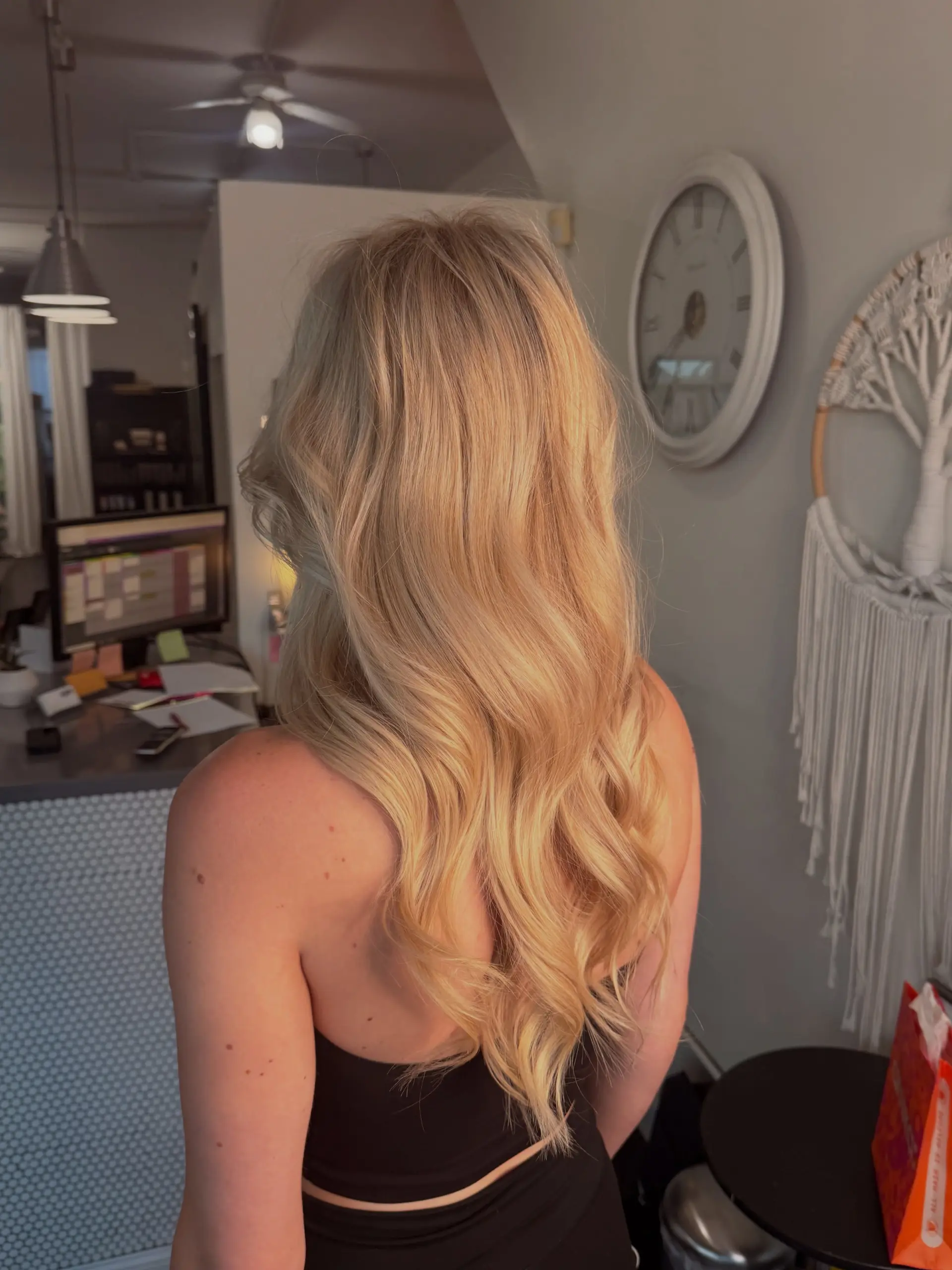 Long warm blonde hair styled in soft, cascading waves. 1