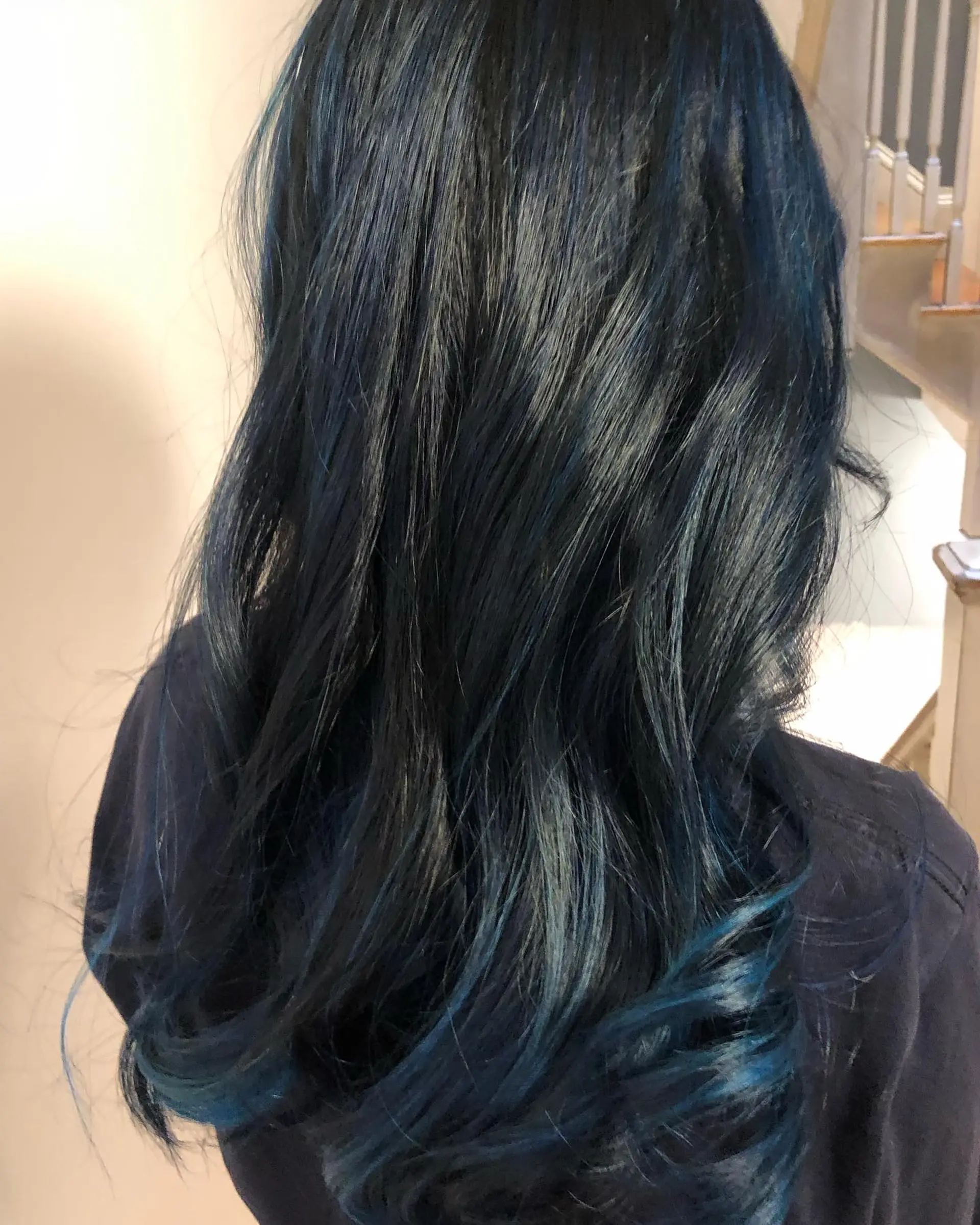 Long hair colored in a rich midnight blue over a dark base, styled with soft curls through the ends. 1