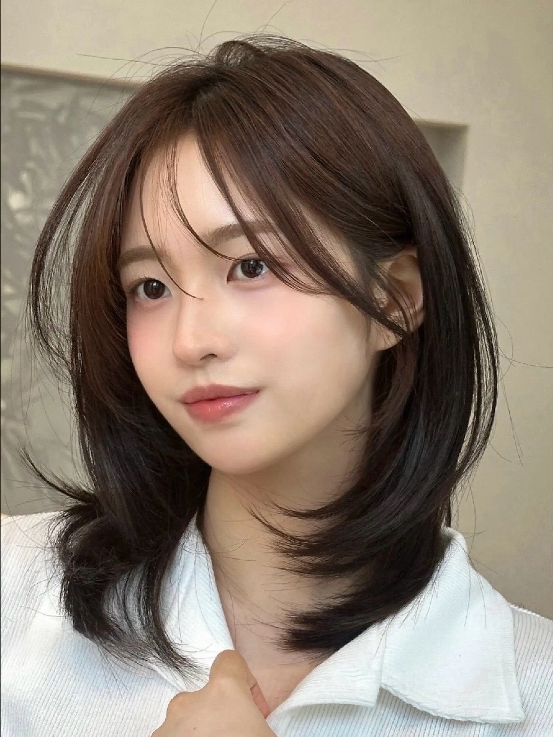 A modern shag haircut with face-framing layers and a center part. 1