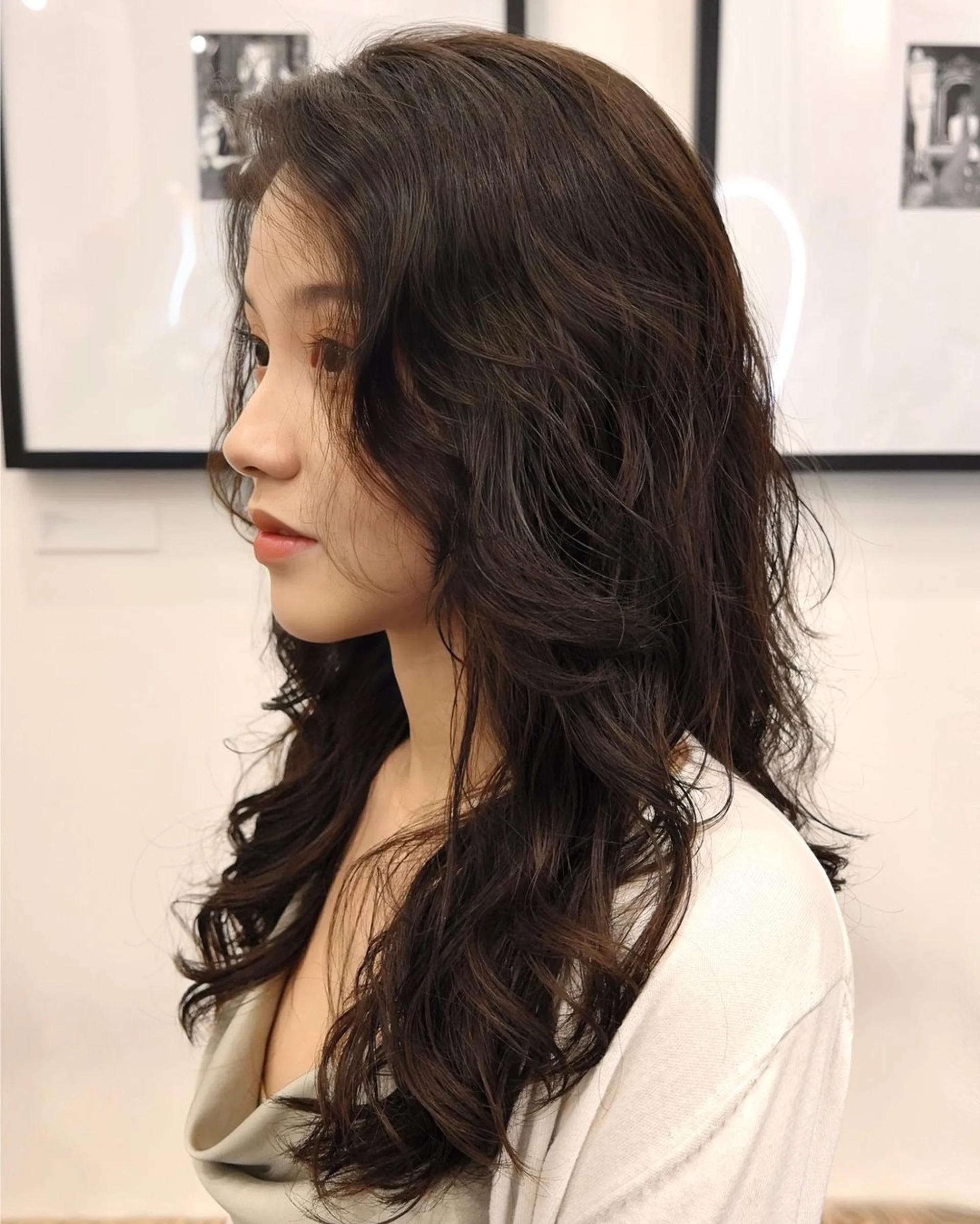 A woman with long, wavy silver and icy blue hair, representing the Digital Hues hair trend for 2026 in NYC. - Preview 2