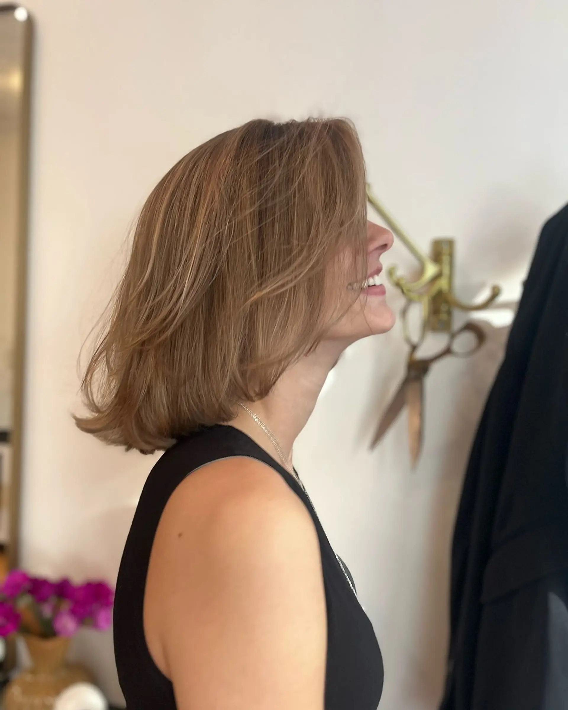 A medium-length, wavy blonde bob with a side part that exudes a soft, chic, and natural elegance. 1