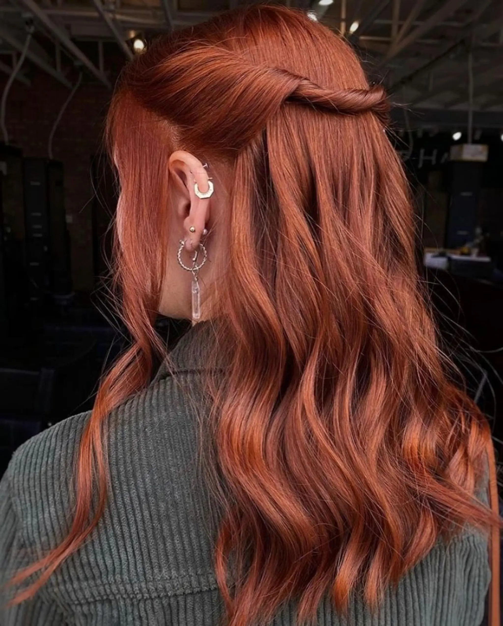 Long, wavy auburn hair with twisted sections forming a half-up, half-down style. @schwarzkopfusa 6-77