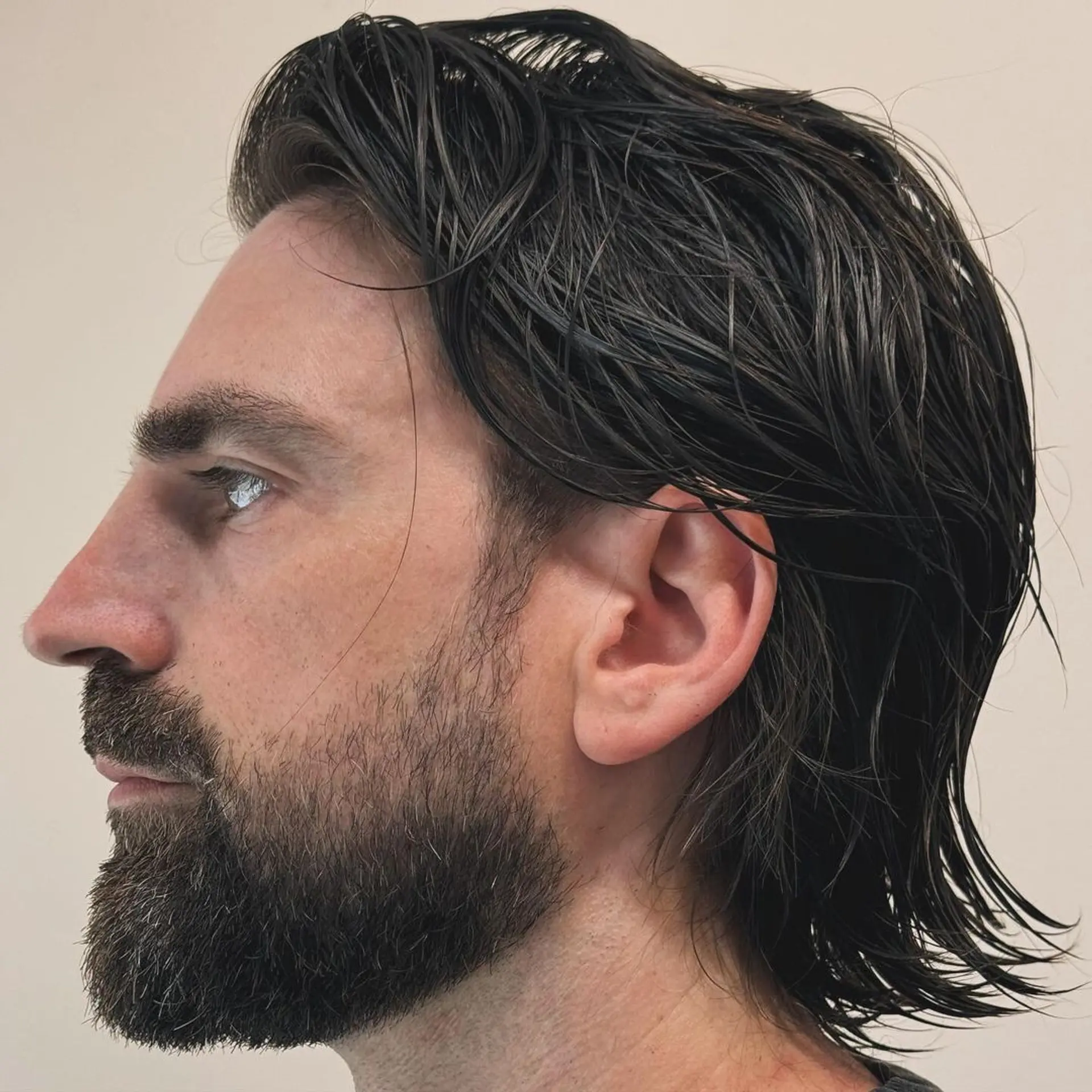 Medium-length, dark brown wavy hair with a sleek, wet look featuring layered, side-swept styling and neck-length cut. 2