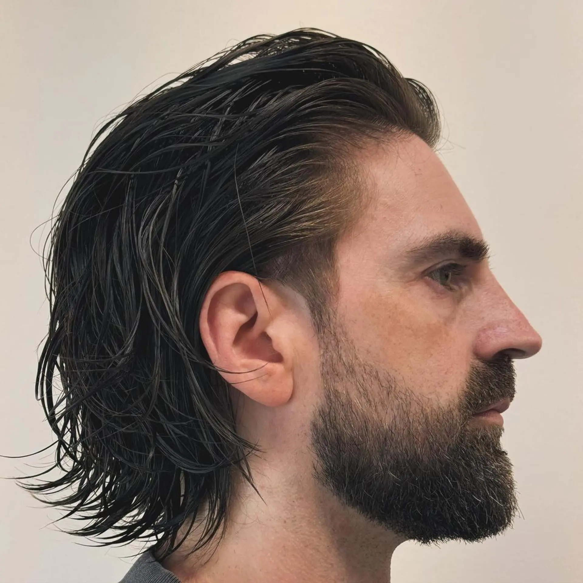 Medium-length, dark brown wavy hair with a sleek, wet look featuring layered, side-swept styling and neck-length cut. 1