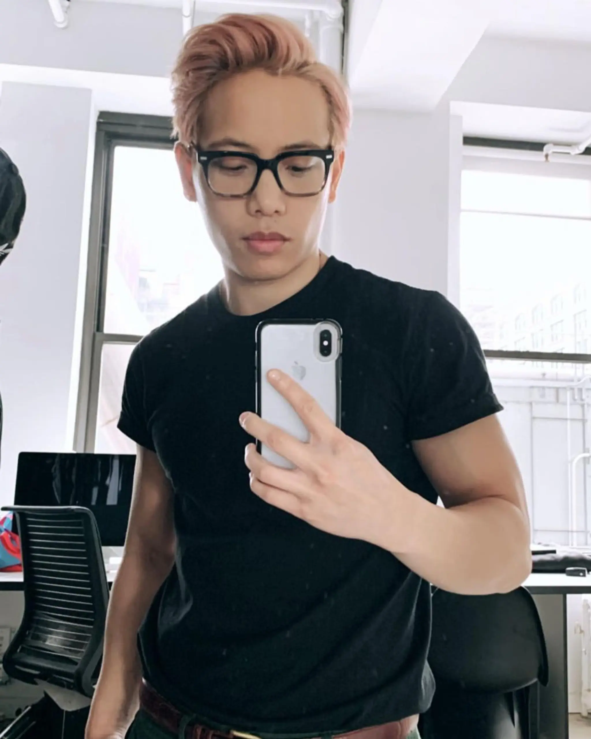 A Short, light pink and peach colored Quiff with a forward sweep, textured volume, and undercut sides for a stylish and modern look.