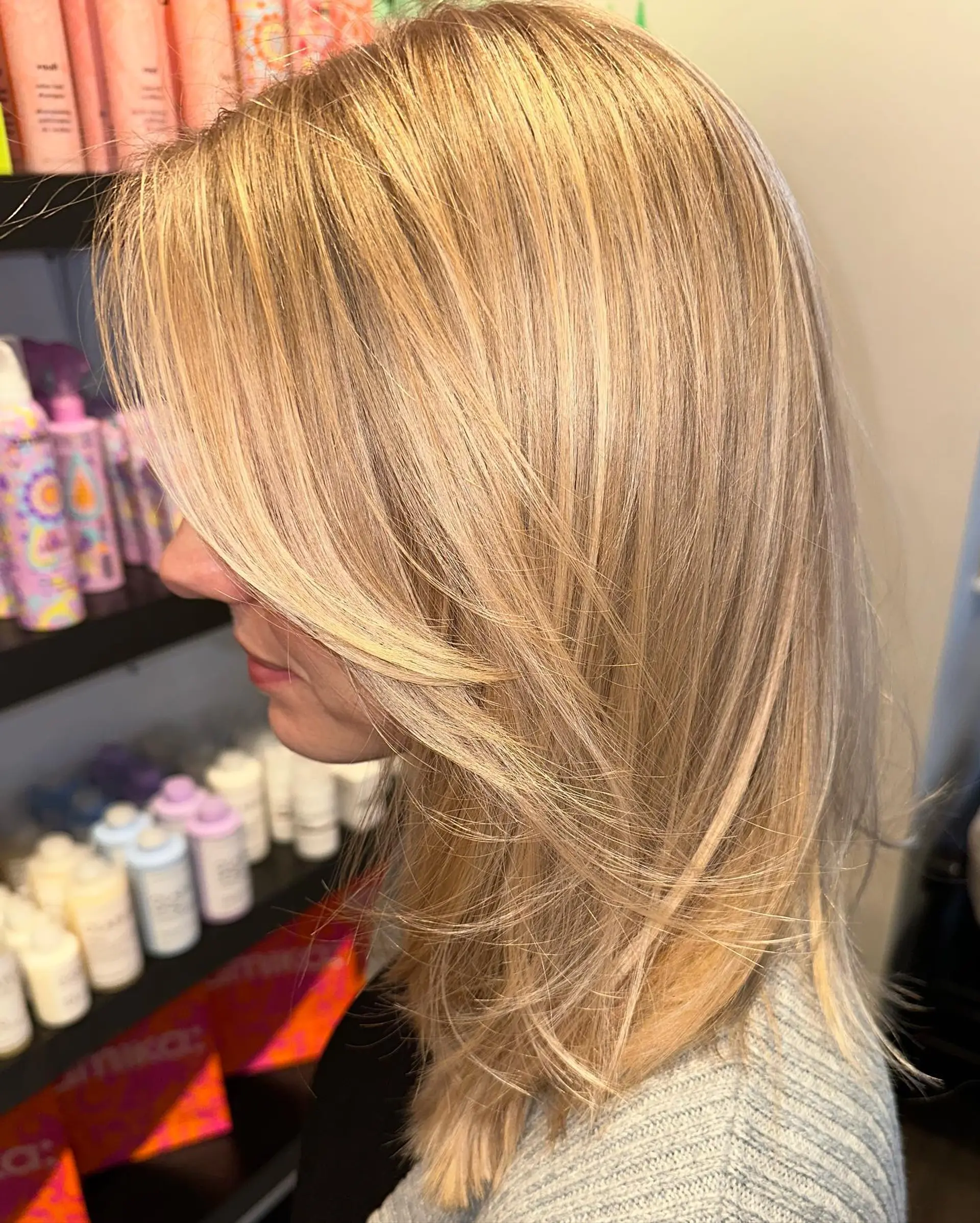 Medium-length straight golden blonde hair cut with delicate face-framing layers and sweeping curtain bangs. 1