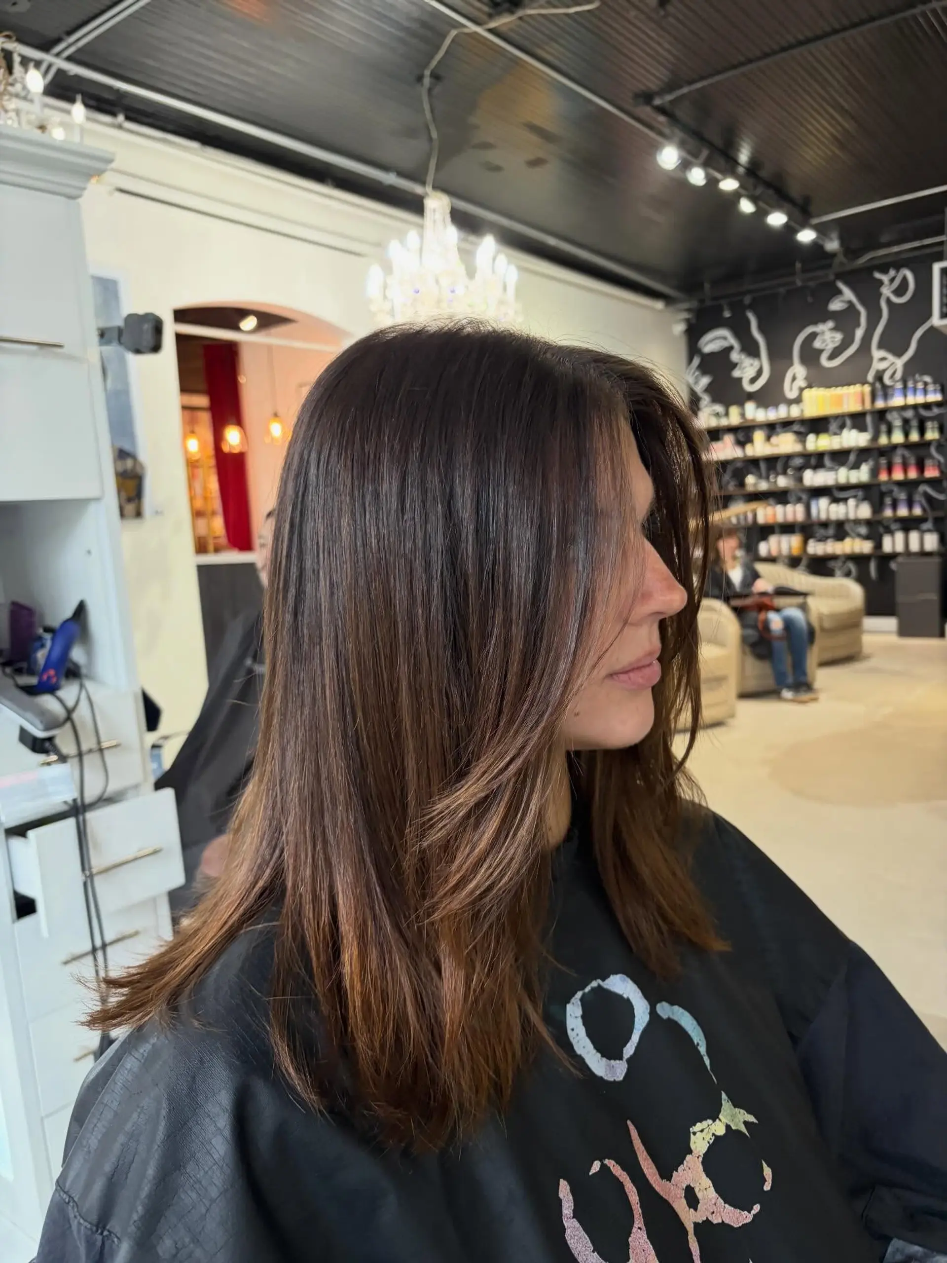 A sleek dark brunette long bob with subtle face-framing layers and a smooth blowout finish. 1