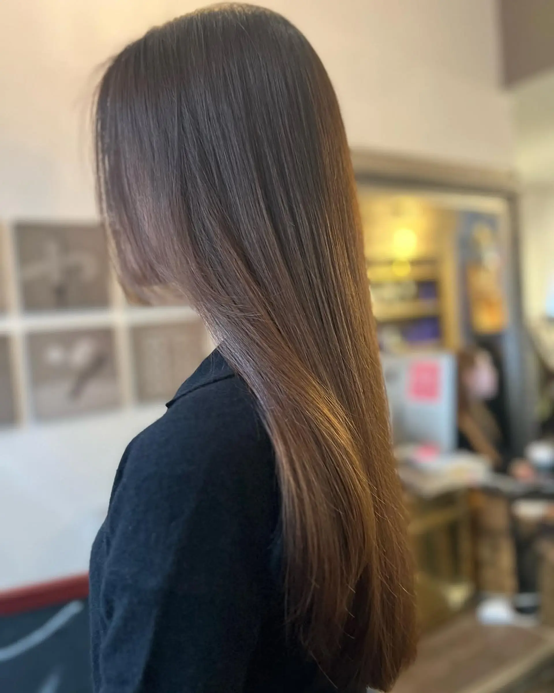 A sleek, long straight hairstyle with a smooth, glossy finish and a subtle side part. 2