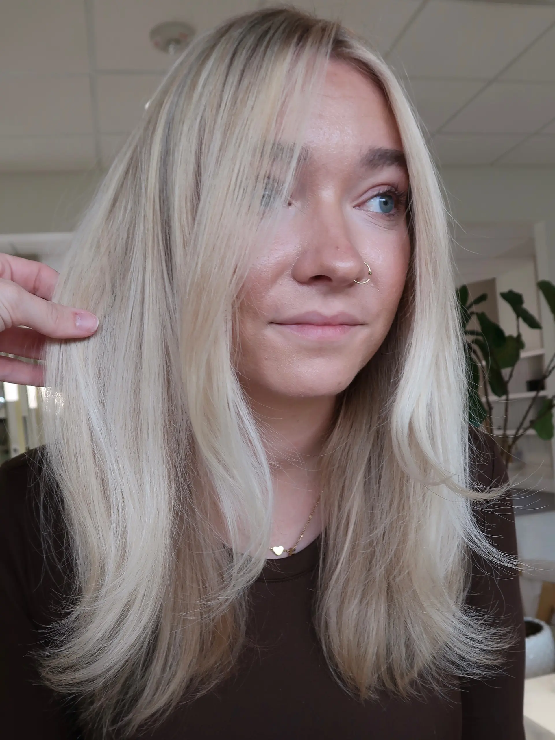 Bright blonde shoulder-length hair styled smooth with softly beveled ends and face-framing layers. 1