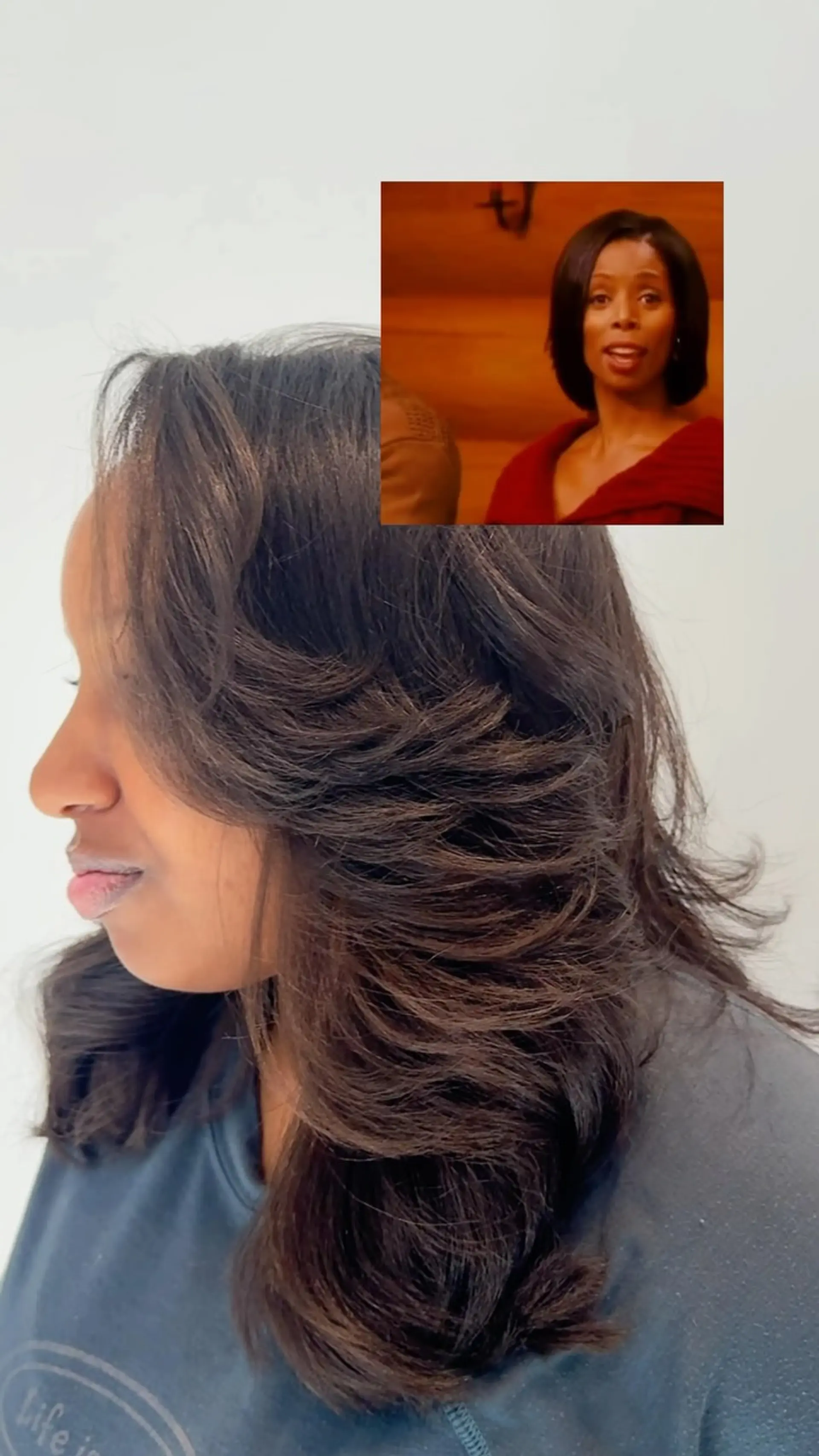 Medium-length dark hair styled in a smooth, voluminous silk press with feathered, flipped-out layers. 1