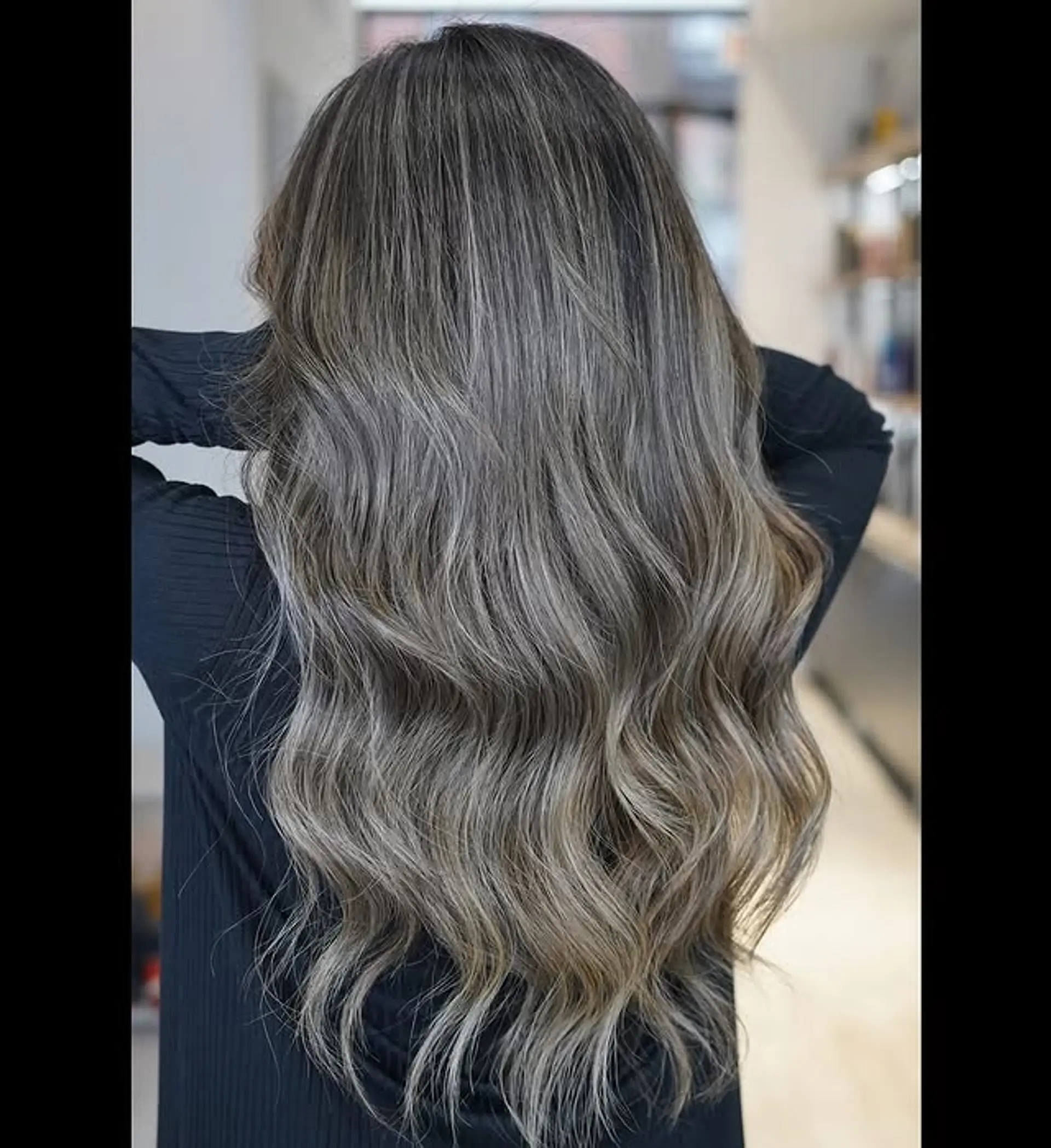 A long, wavy hairstyle featuring an ash blonde balayage. 1