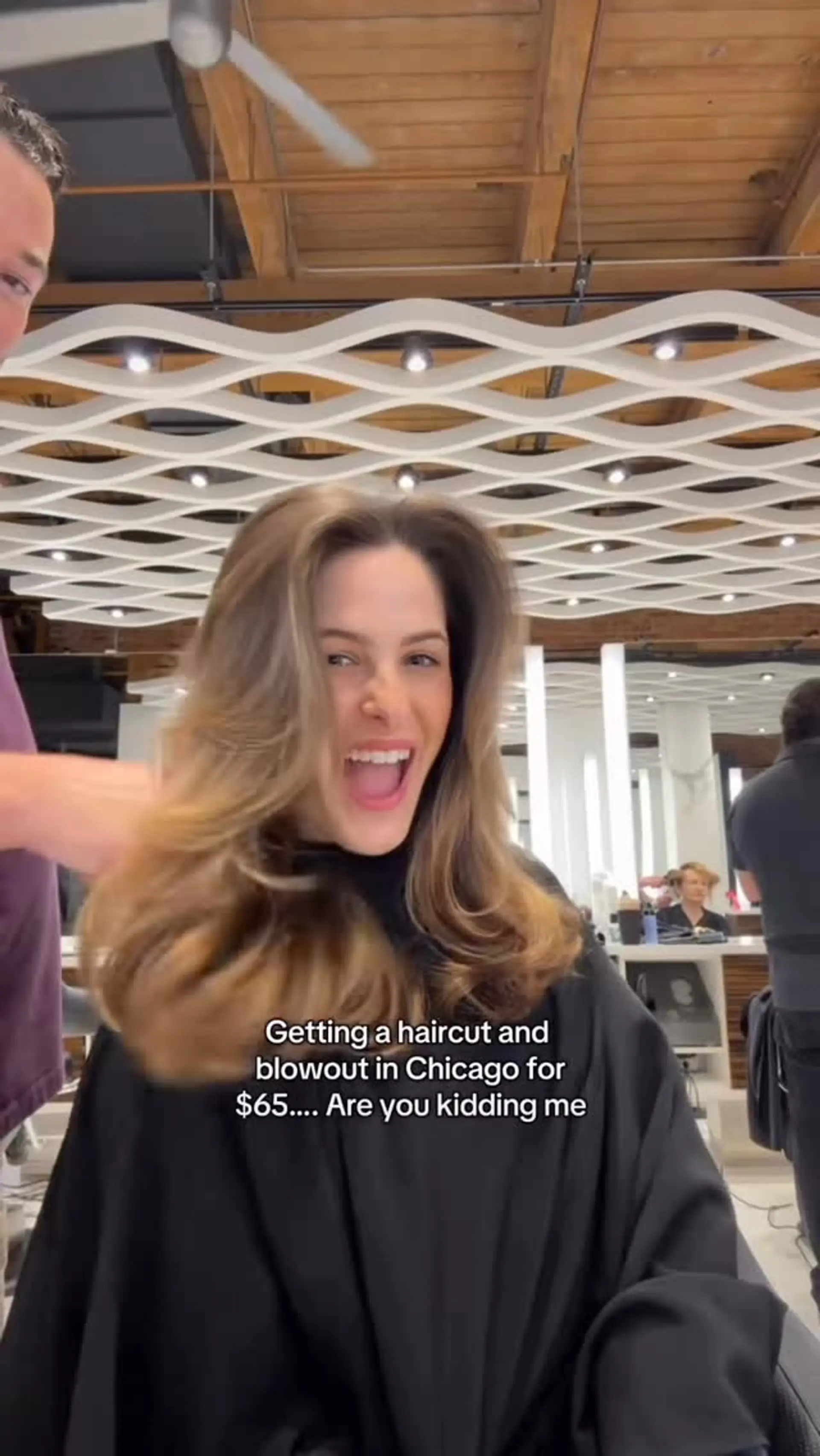 A bouncy, voluminous blowout on medium-length layered hair with face-framing dimension and soft flipped ends. 1