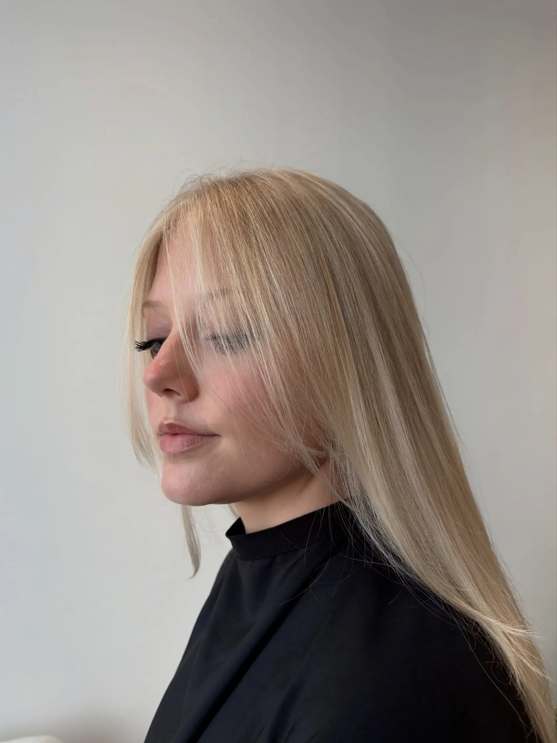 A sleek, long platinum blonde hairstyle featuring delicate, wispy face-framing fringe. 1