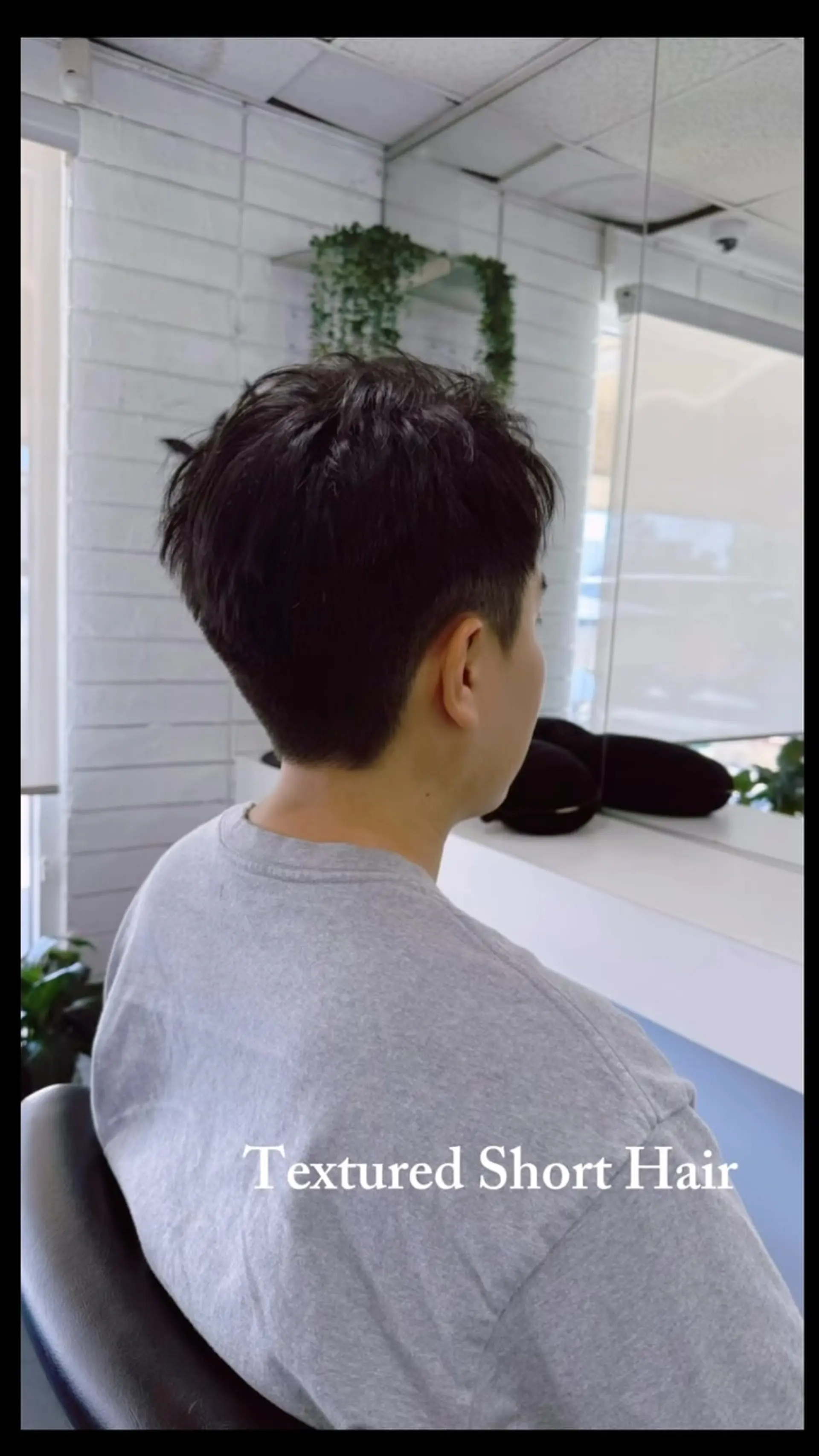 A textured short haircut featuring tapered sides and a layered crown for effortless movement. 1