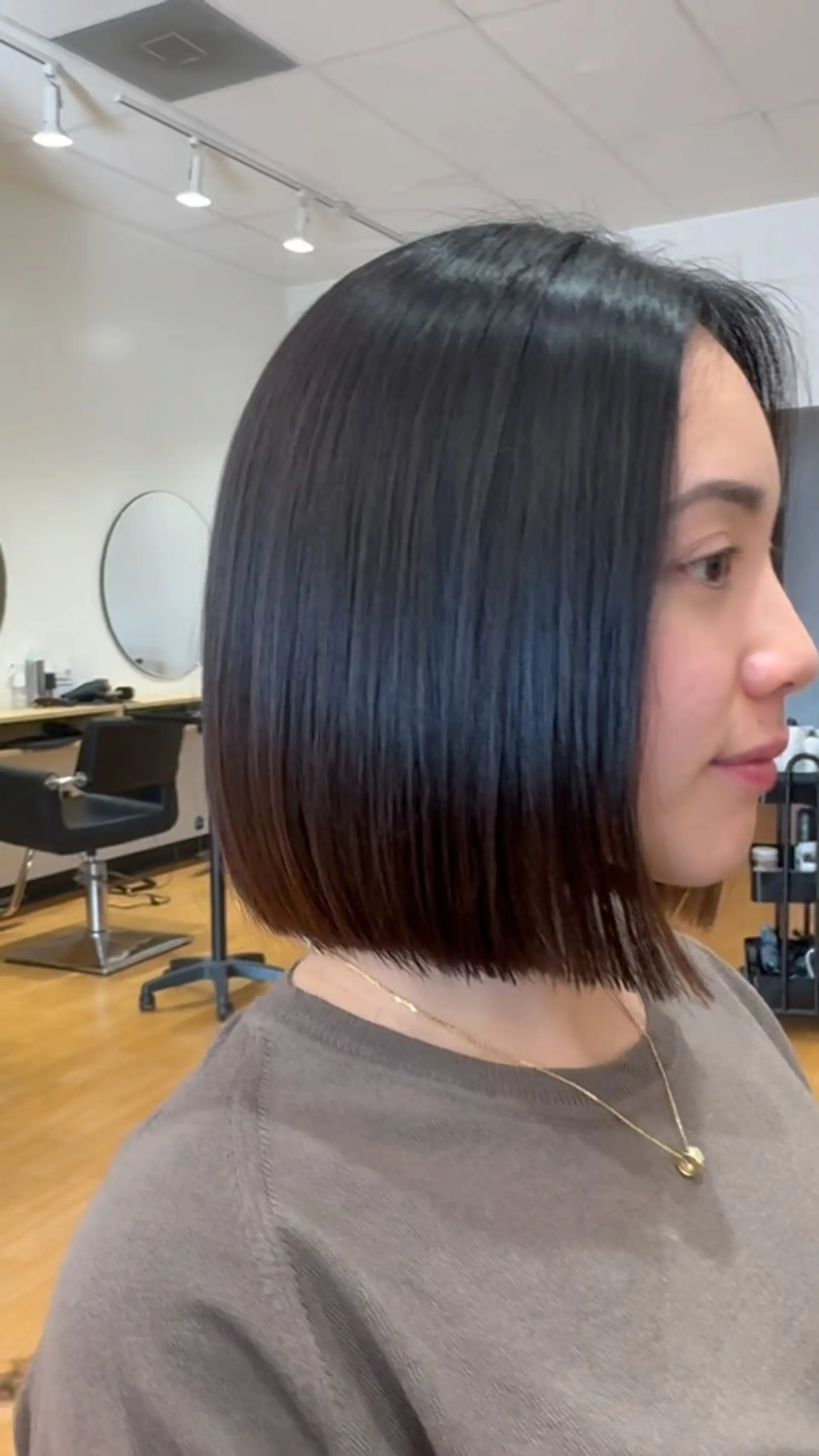 A sleek, chin-length blunt bob cut straight across with a high-shine finish. 1