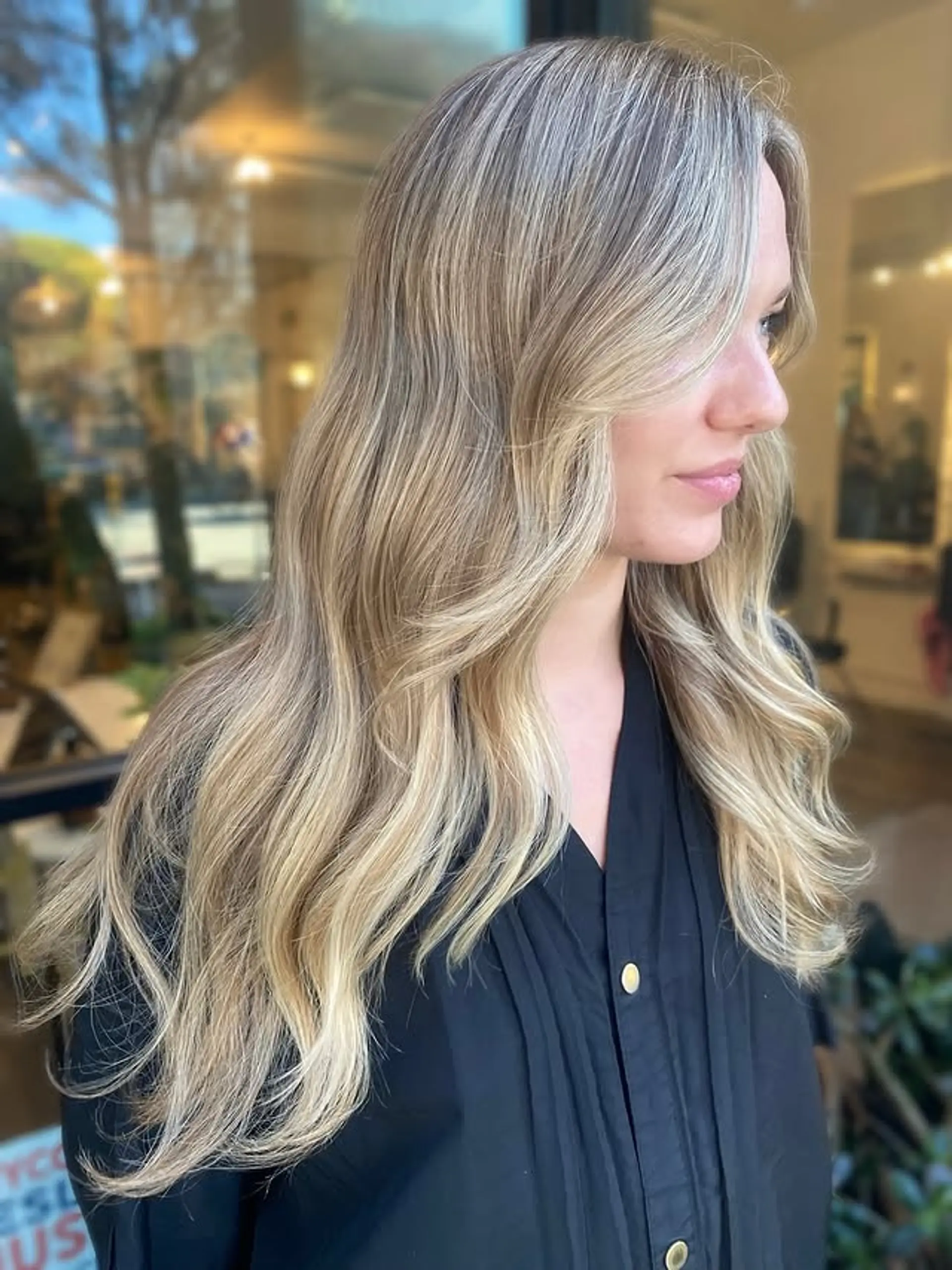 Long, beachy waves with curtain bangs and face-framing layers. 1