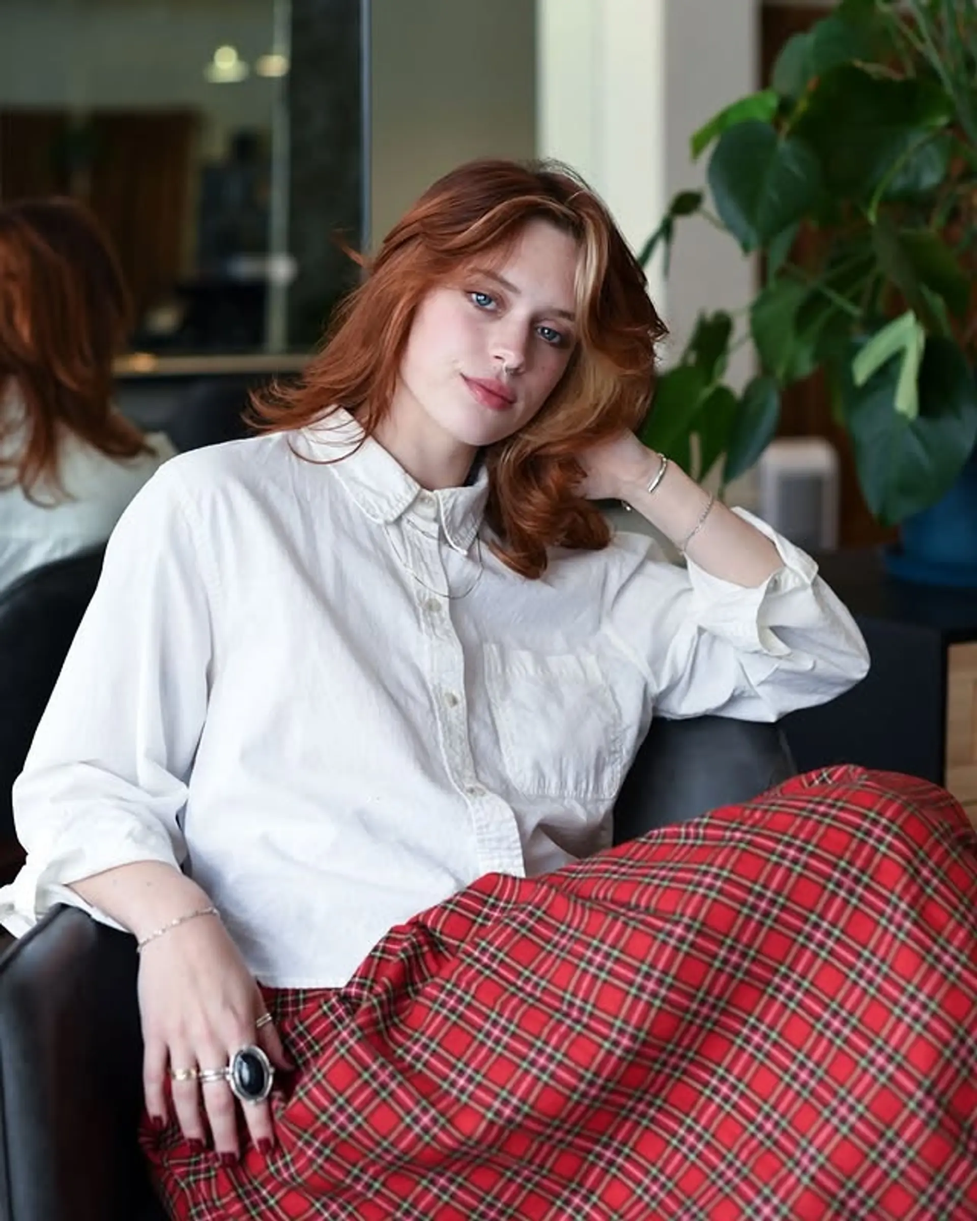 A copper shag haircut with face-framing blonde highlights and layered waves. 1