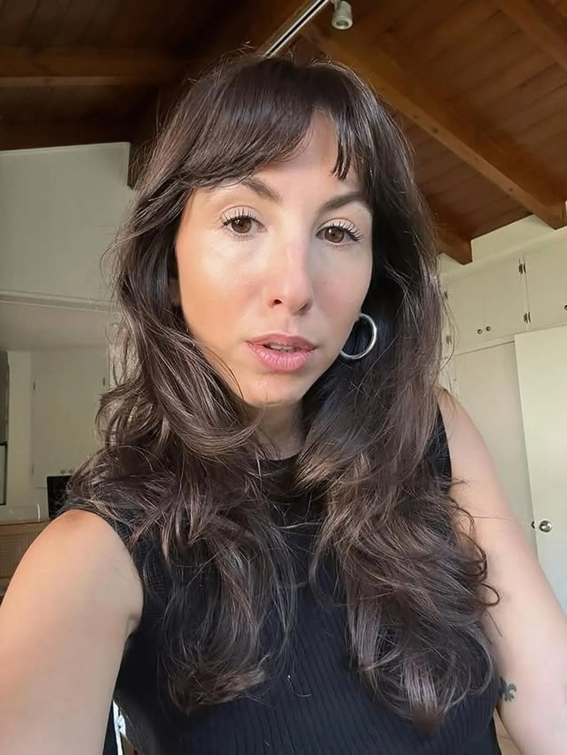 A long, wavy shag haircut with face-framing layers and curtain bangs. 1