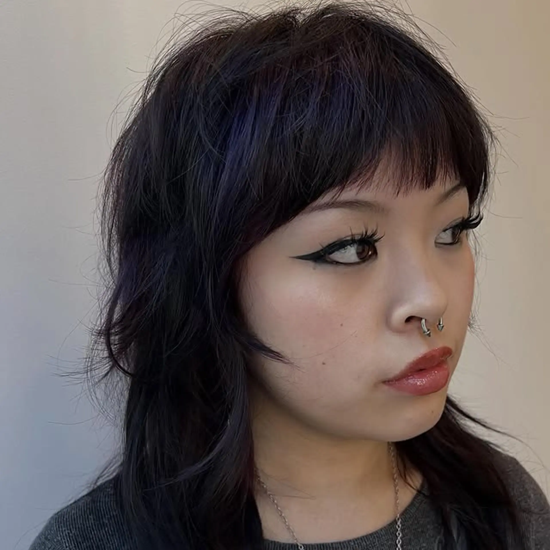 A contemporary take on the classic mullet, featuring shaggy layers and edgy bangs. 1