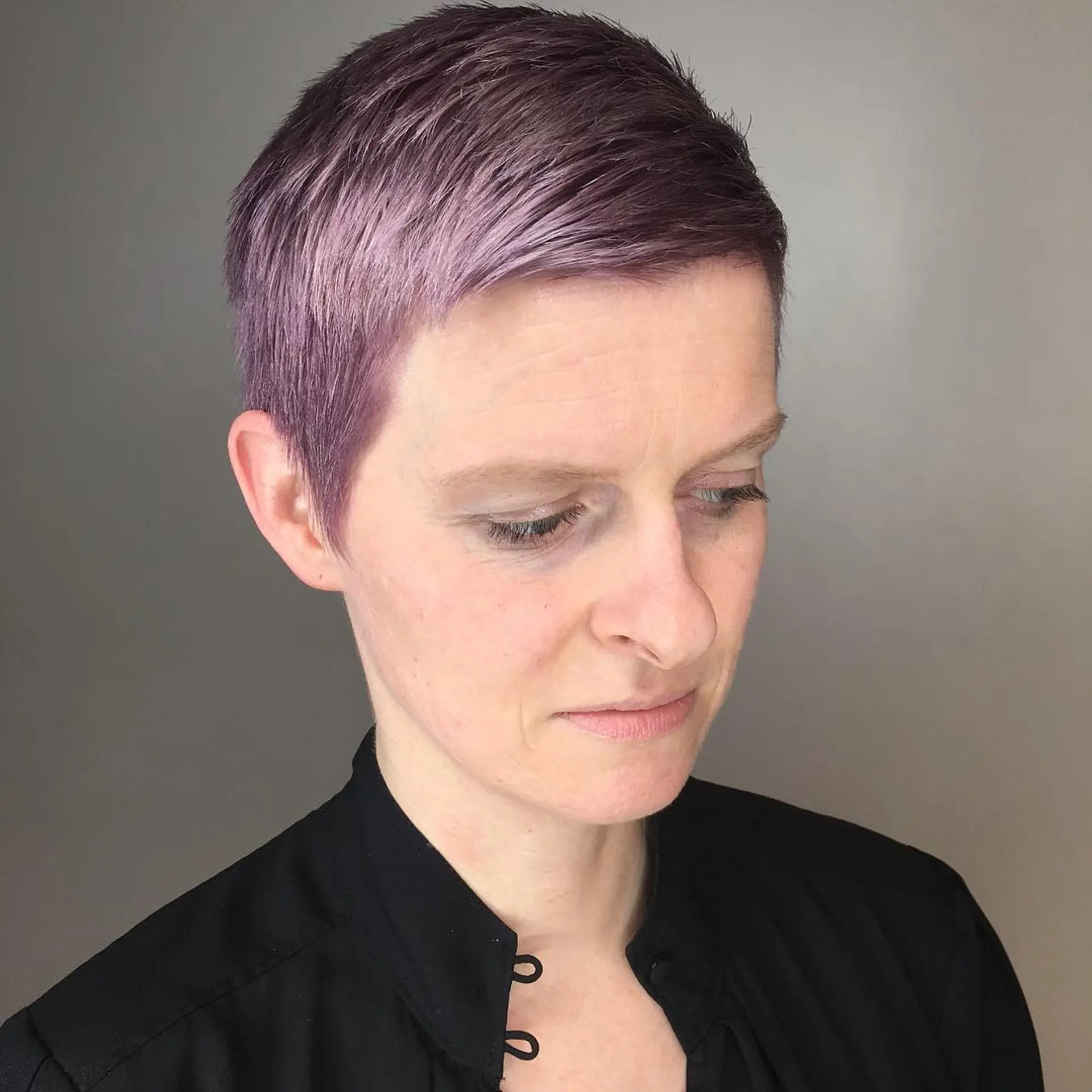 A textured short pixie cut colored in a soft metallic mauve quartz and lavender pastel tone. 1