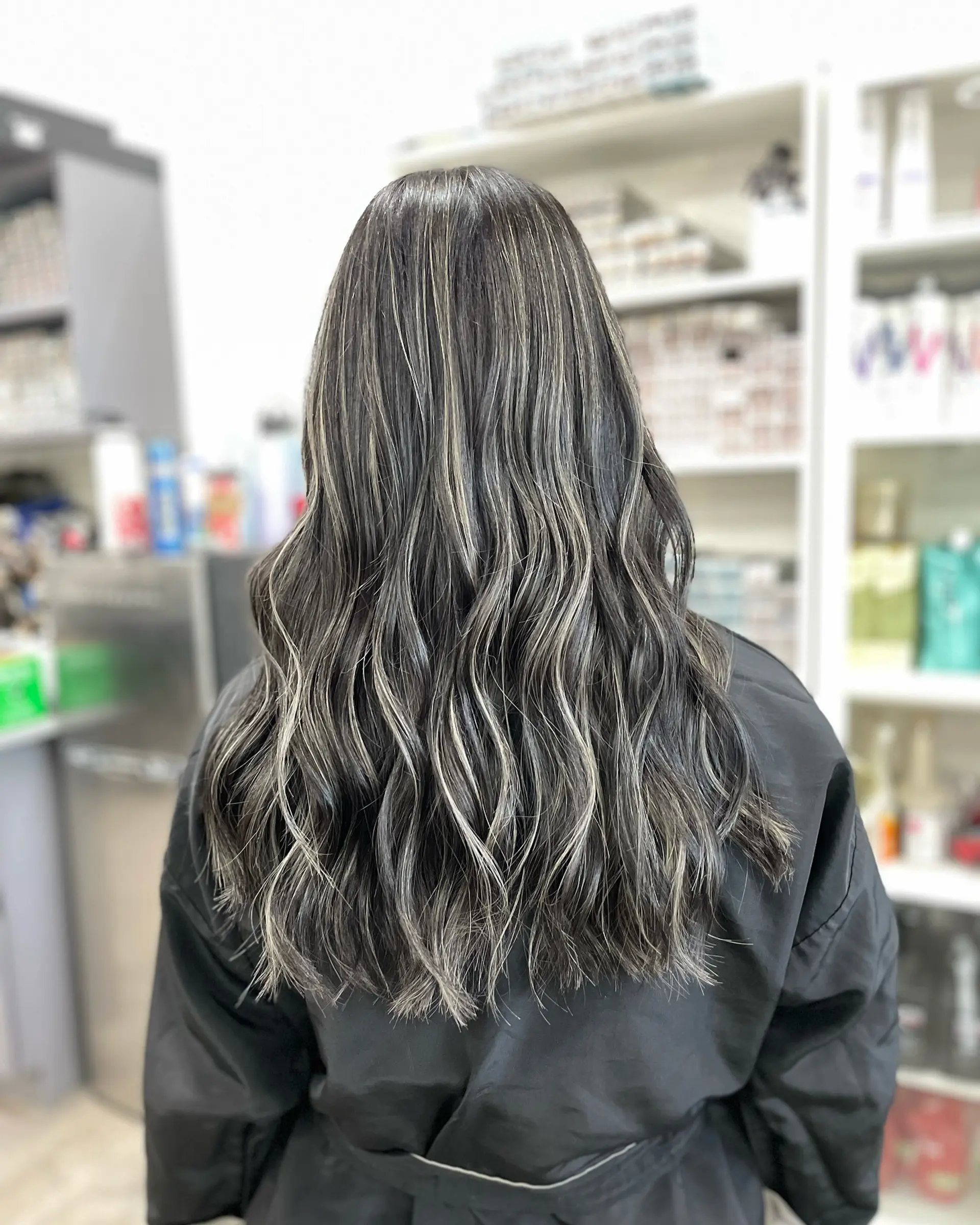 Long wavy hair with silver highlights. 1