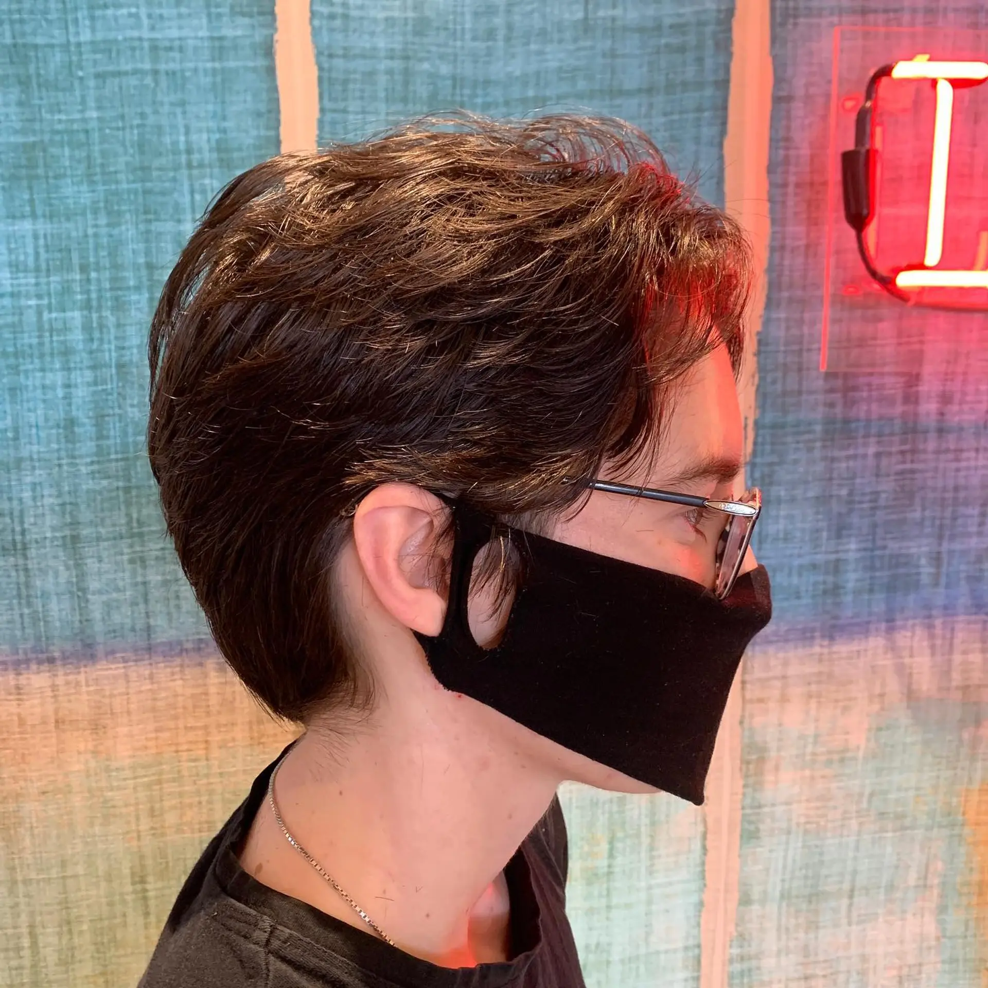 A short, textured haircut with a focus on creating movement and definition. 1