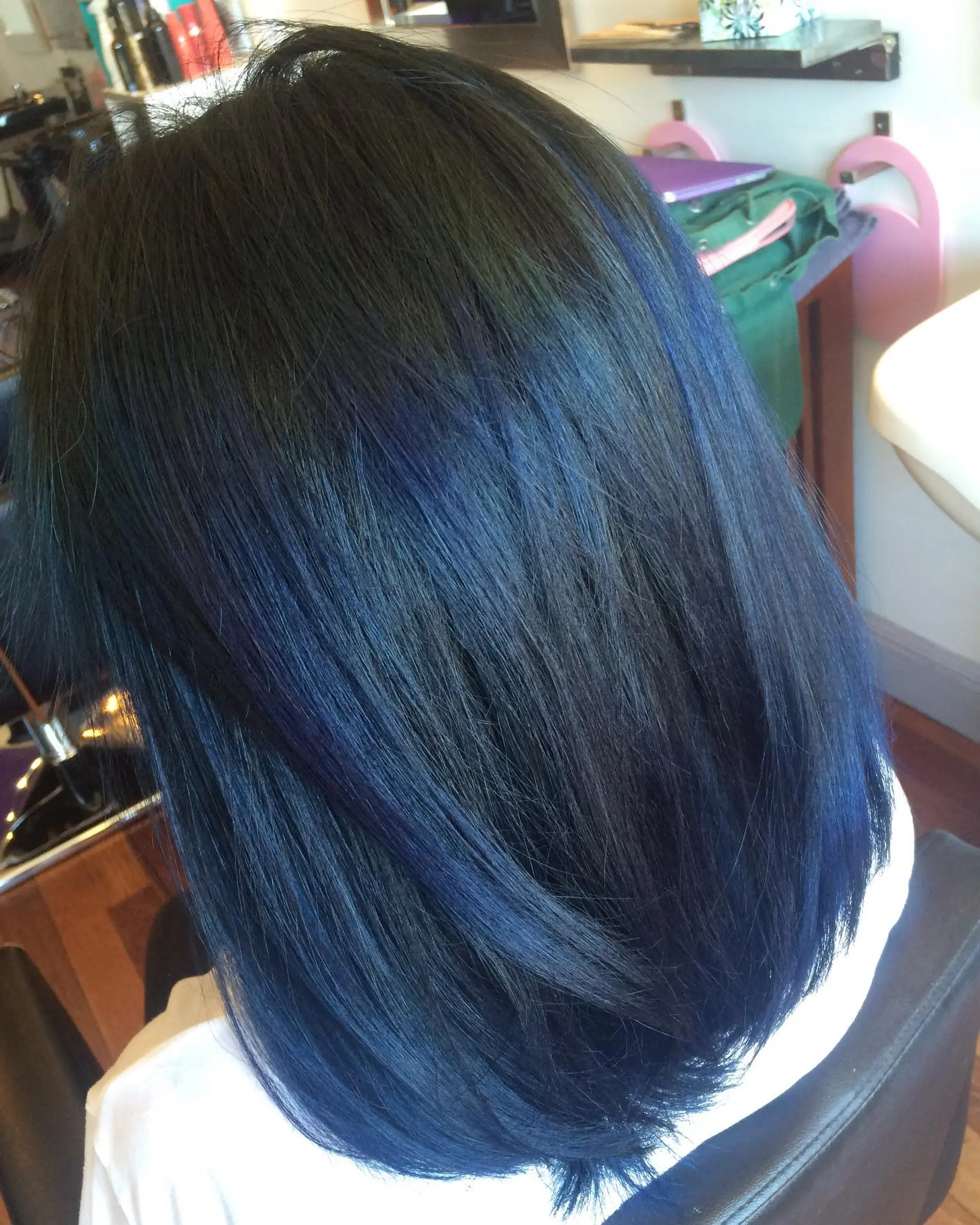 Shoulder-length straight dark hair featuring seamless midnight blue balayage highlights. 1