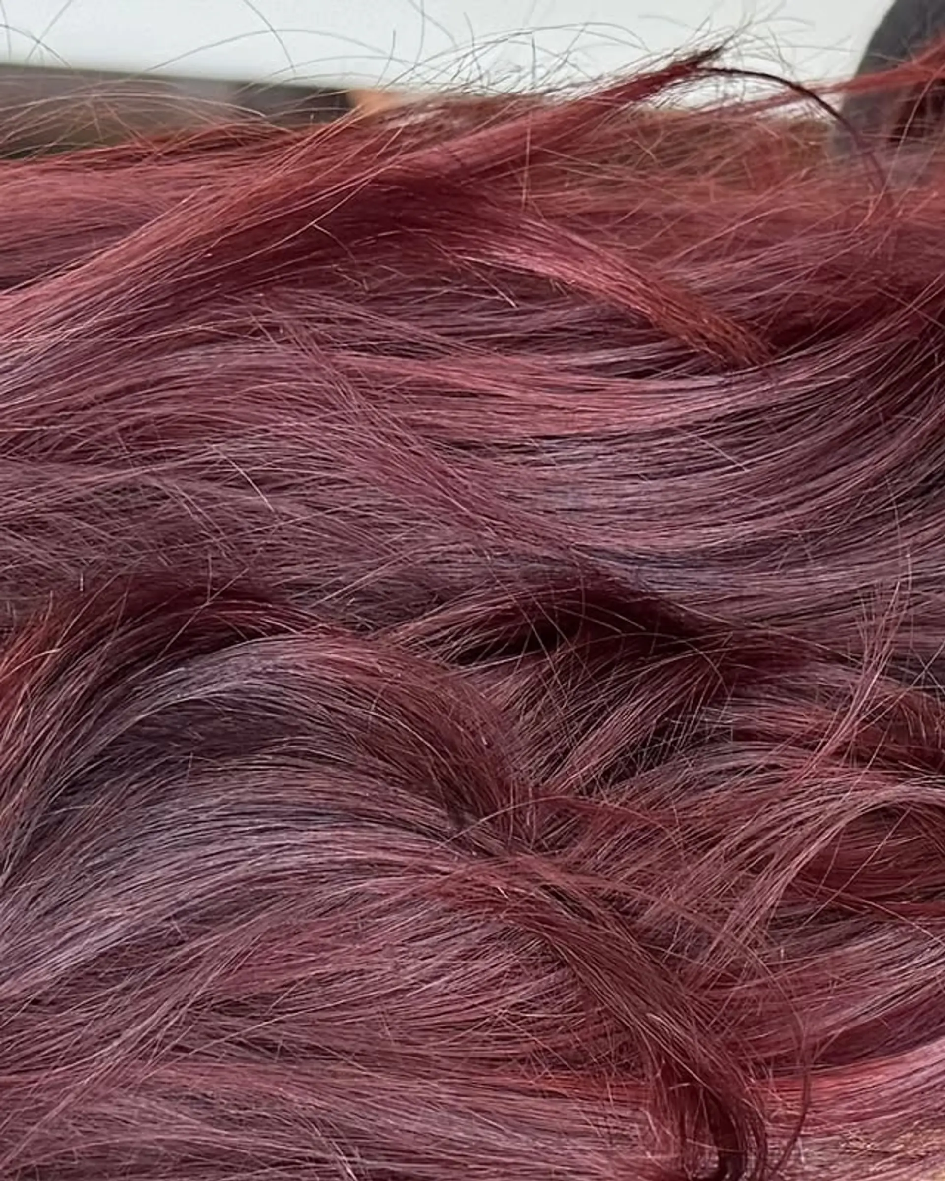 Straight brunette hair with a burgundy balayage. 1