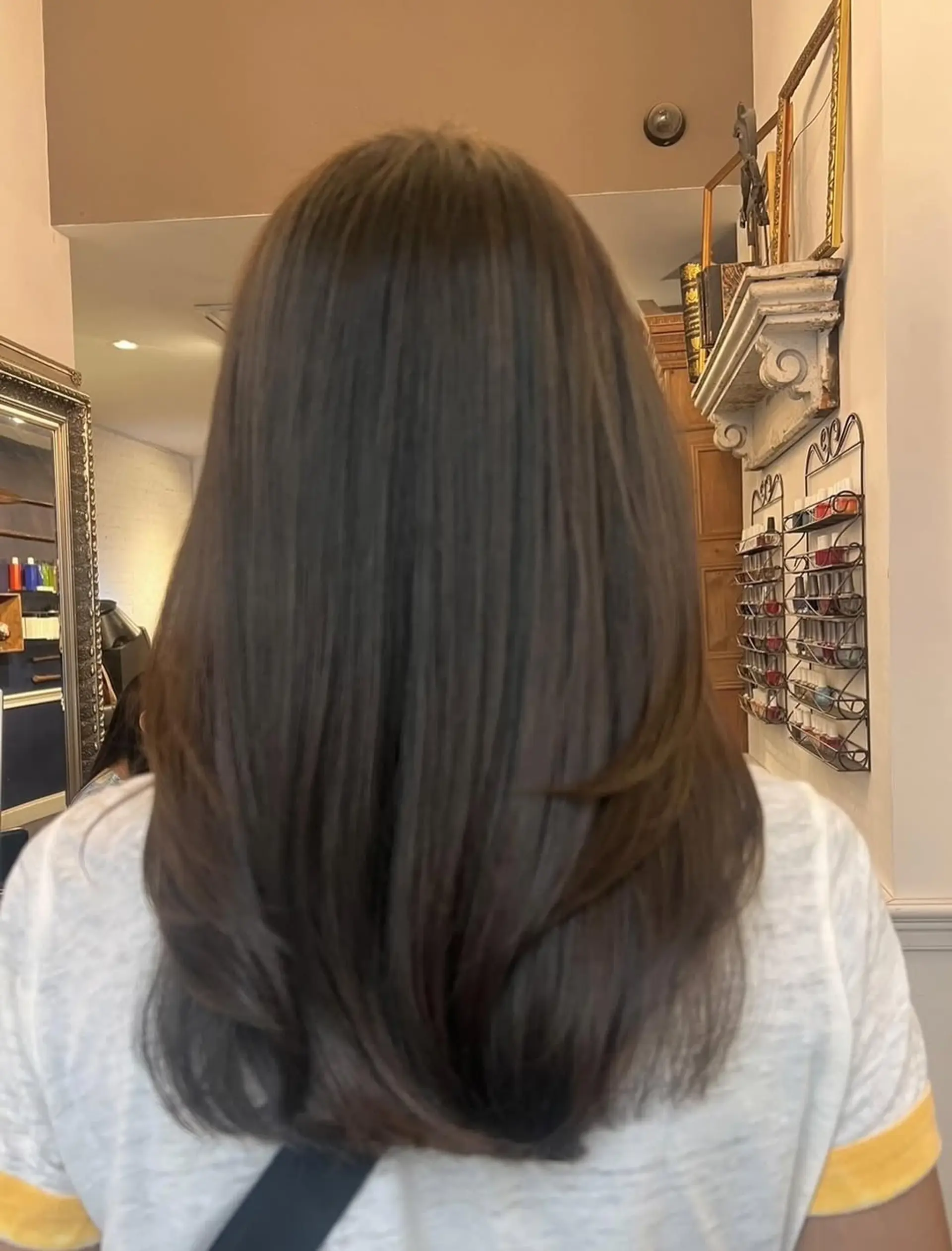 Long, straight, dark brown hair with smooth layers and a sleek, naturally shiny finish. 1