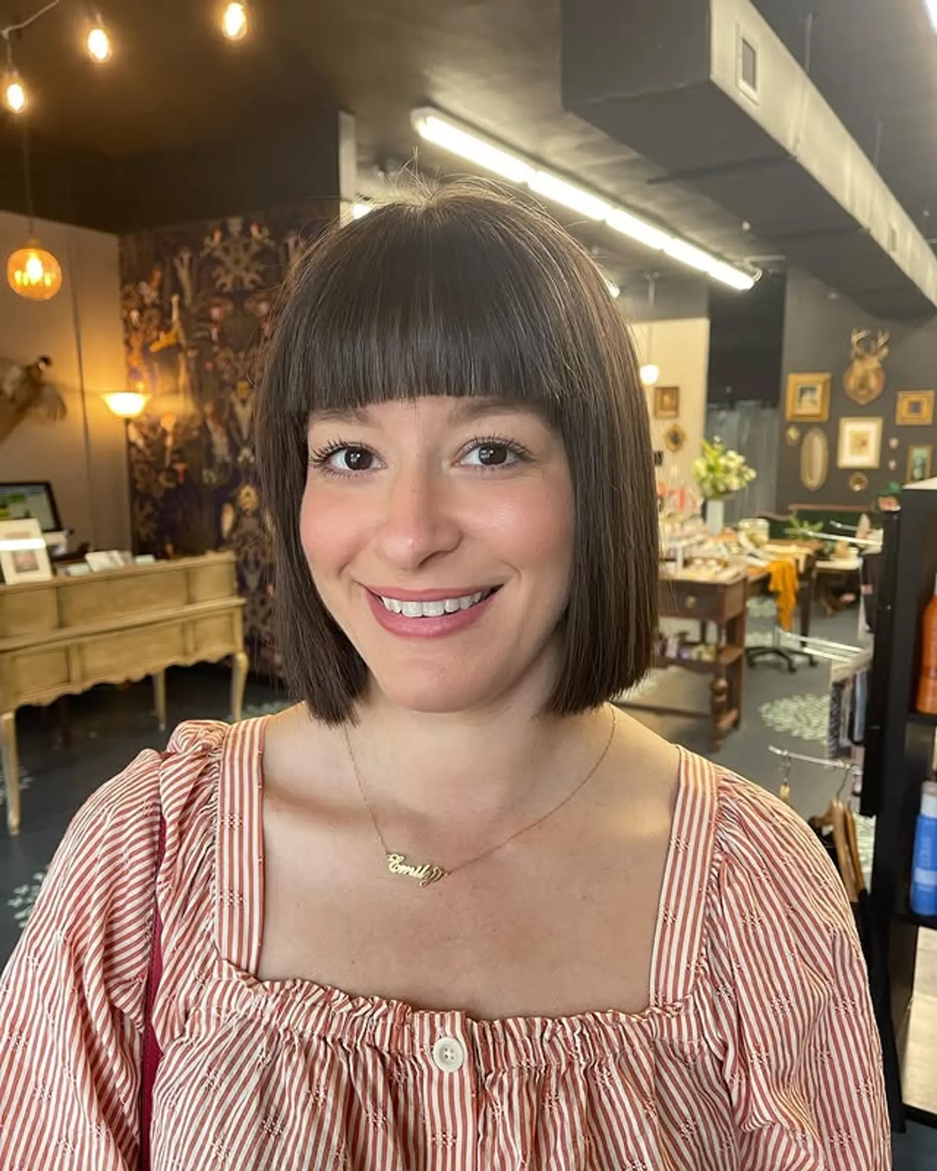 A sharp, straight-across blunt bob with a full fringe. 1