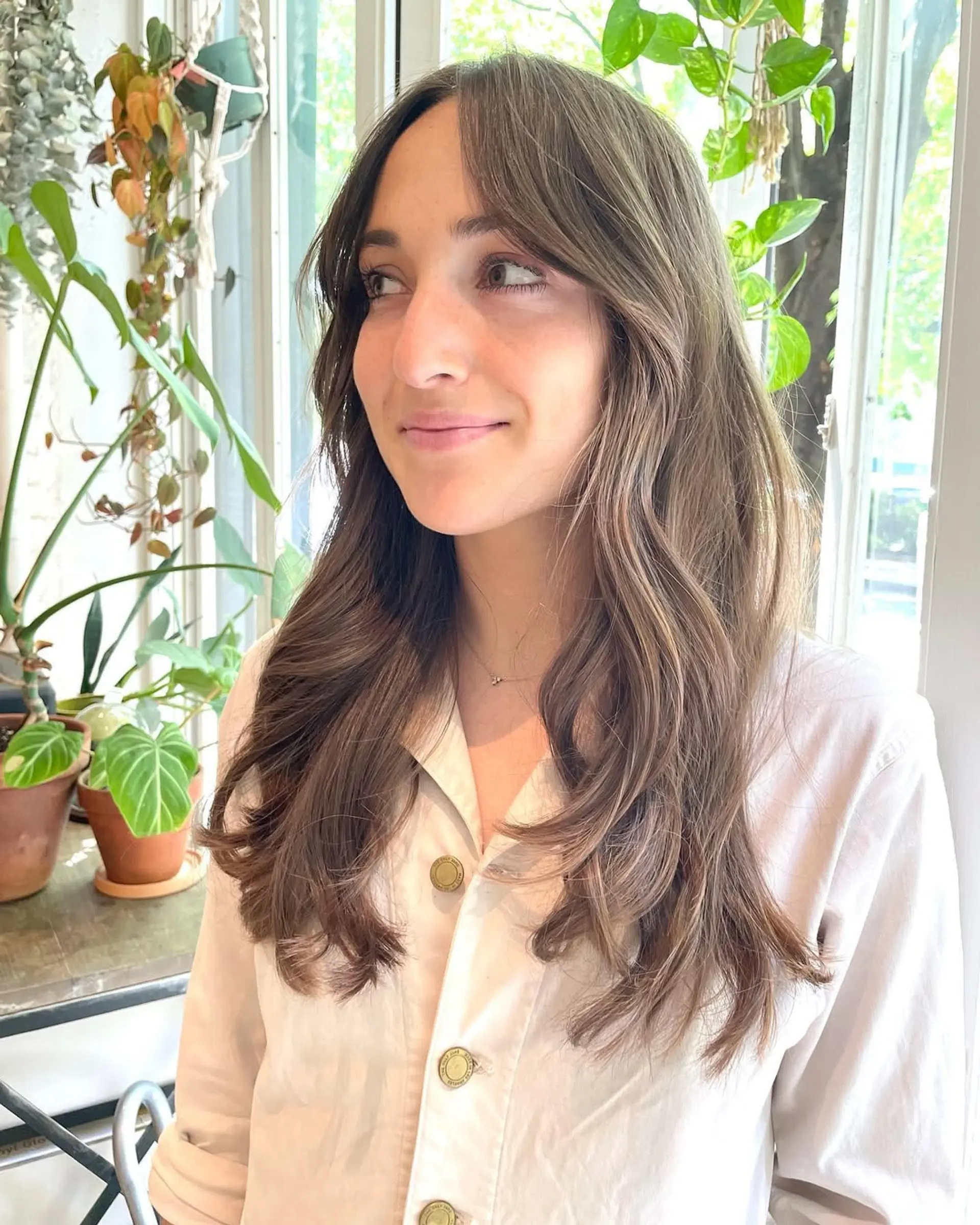 Long, wavy hair with layers and face-framing bangs. 1