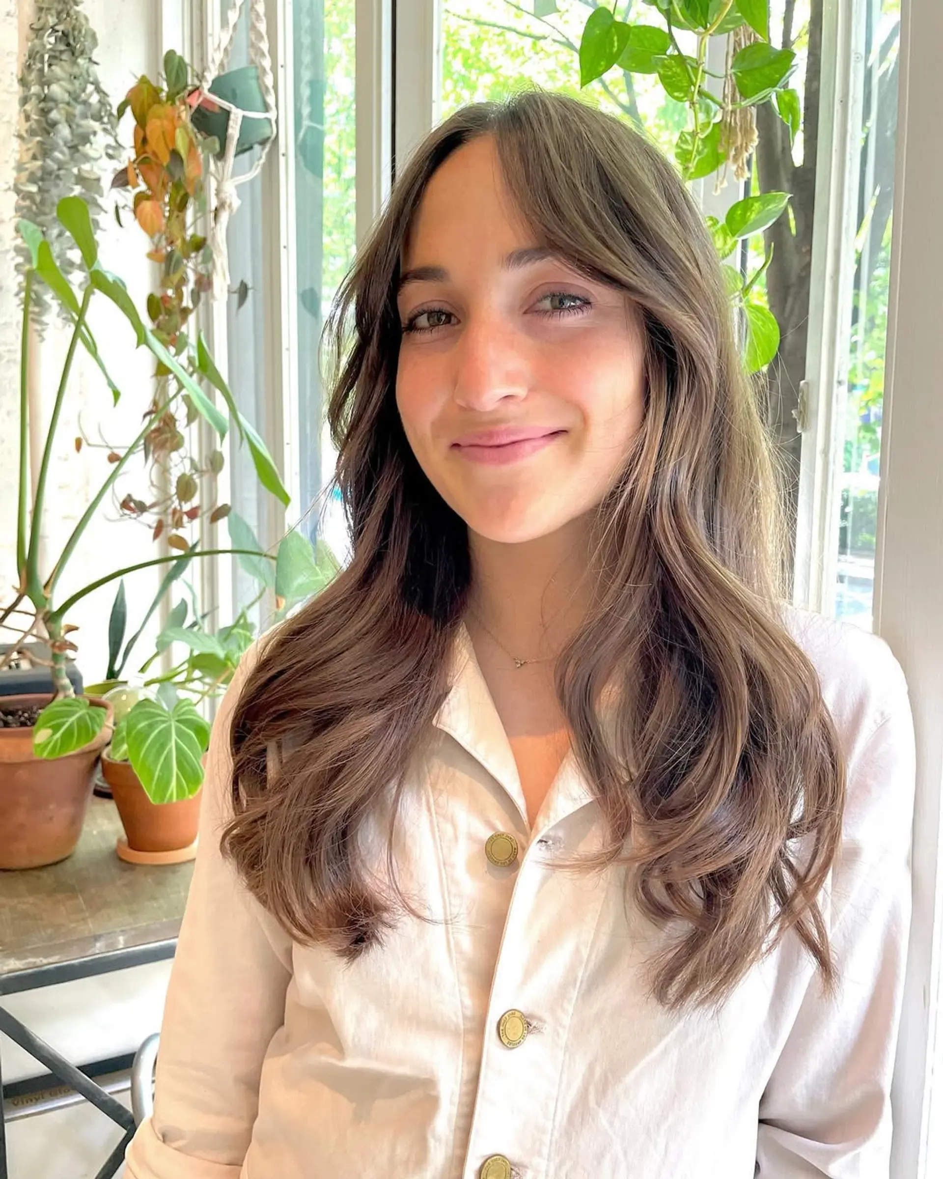 Long, wavy hair with layers and face-framing bangs. 2