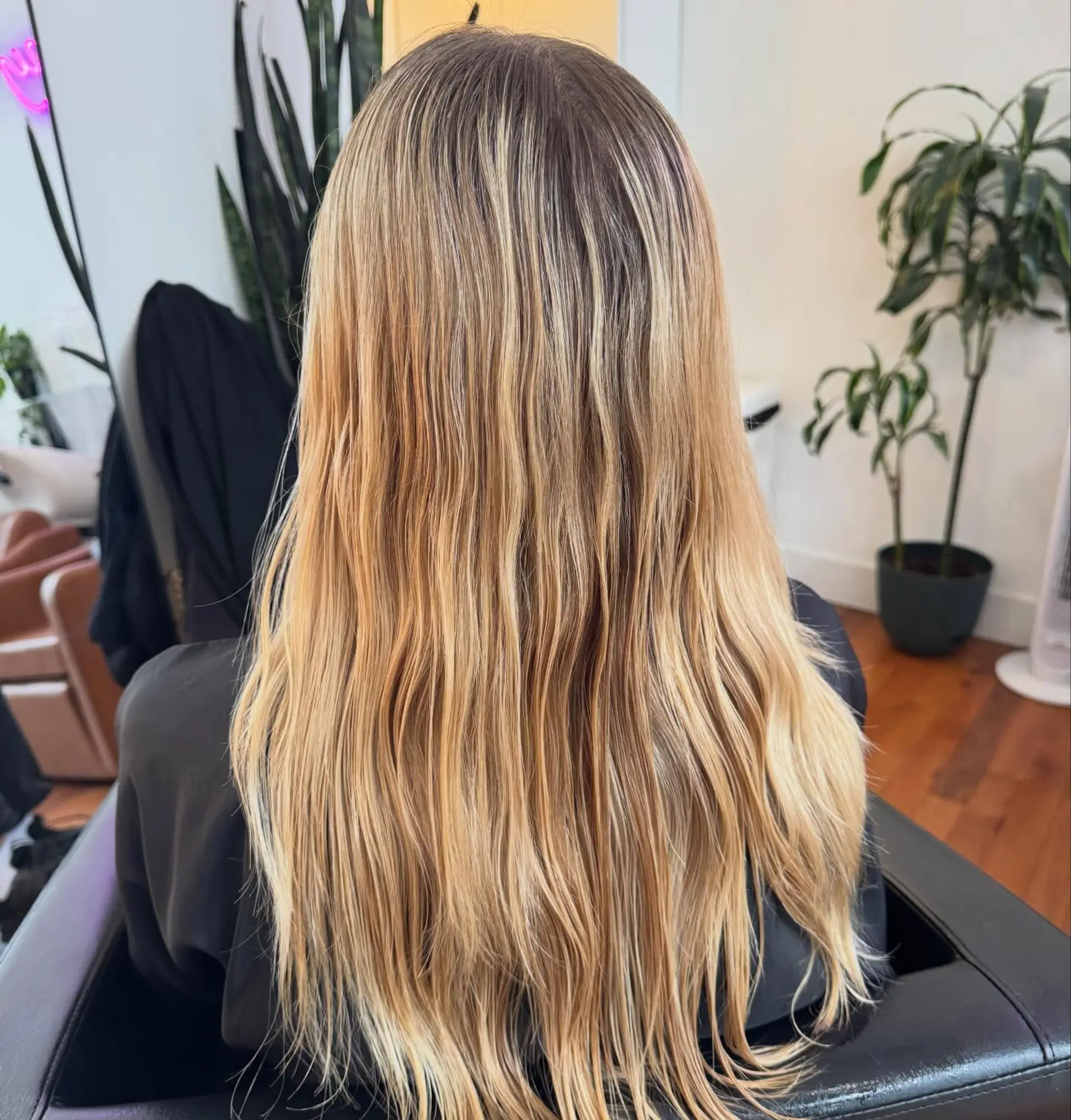 Long hair featuring warm golden and honey blonde highlights blended seamlessly with a natural darker root. 1